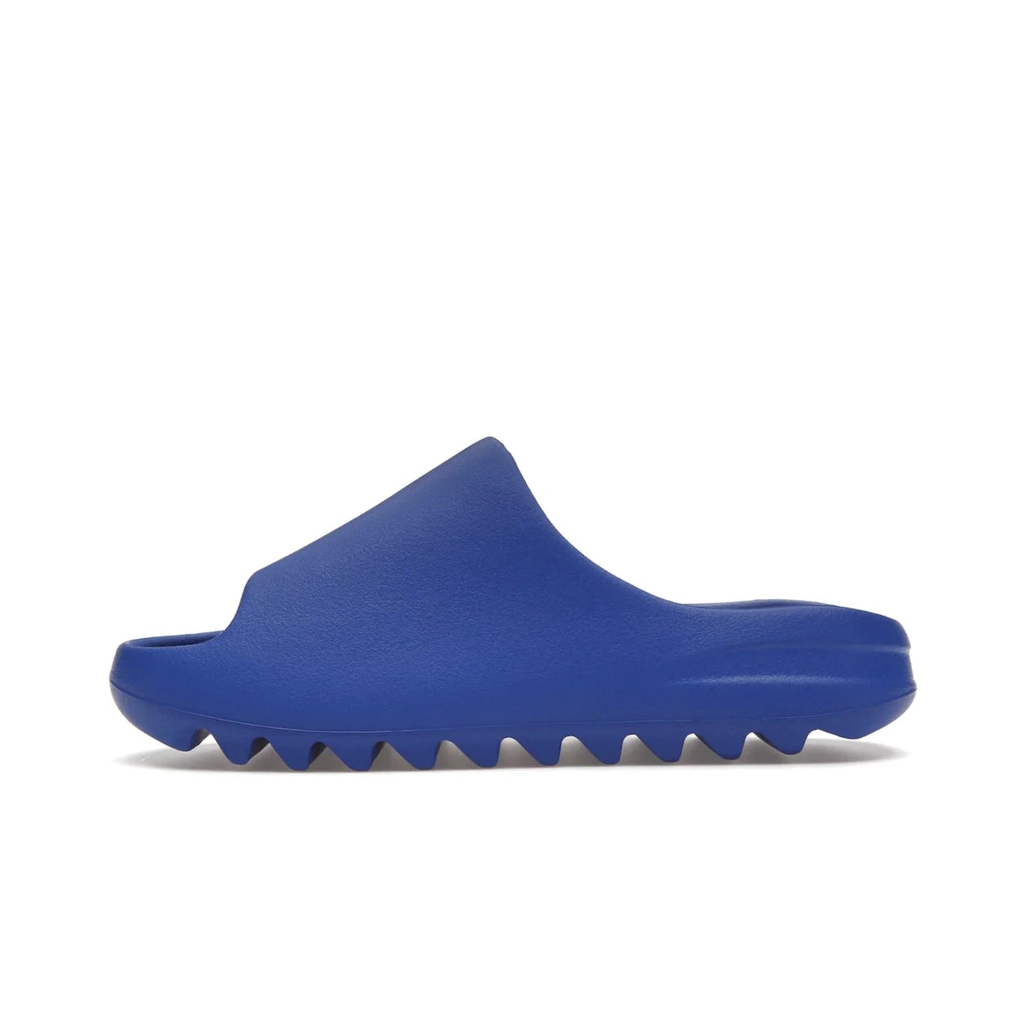 adidas Yeezy Slide Azure - Image 19 - Only at www.BallersClubKickz.com - Elevate your look with the adidas Yeezy Slide Azure. Boasting a vibrant hue for a unique style, this EVA foam slide is a statement of fearlessness and stylish expression. Step out with confidence knowing you're wearing more than a slide.
