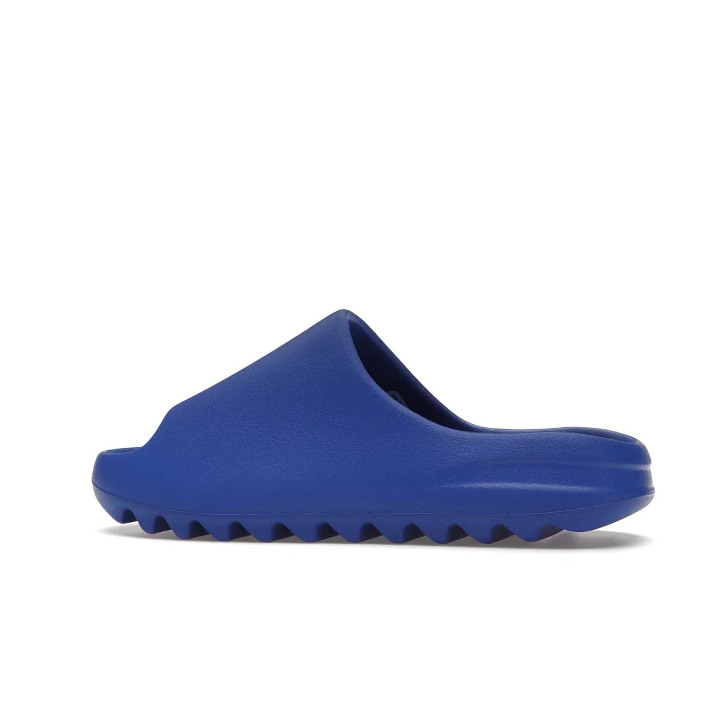 adidas Yeezy Slide Azure - Image 21 - Only at www.BallersClubKickz.com - Elevate your look with the adidas Yeezy Slide Azure. Boasting a vibrant hue for a unique style, this EVA foam slide is a statement of fearlessness and stylish expression. Step out with confidence knowing you're wearing more than a slide.