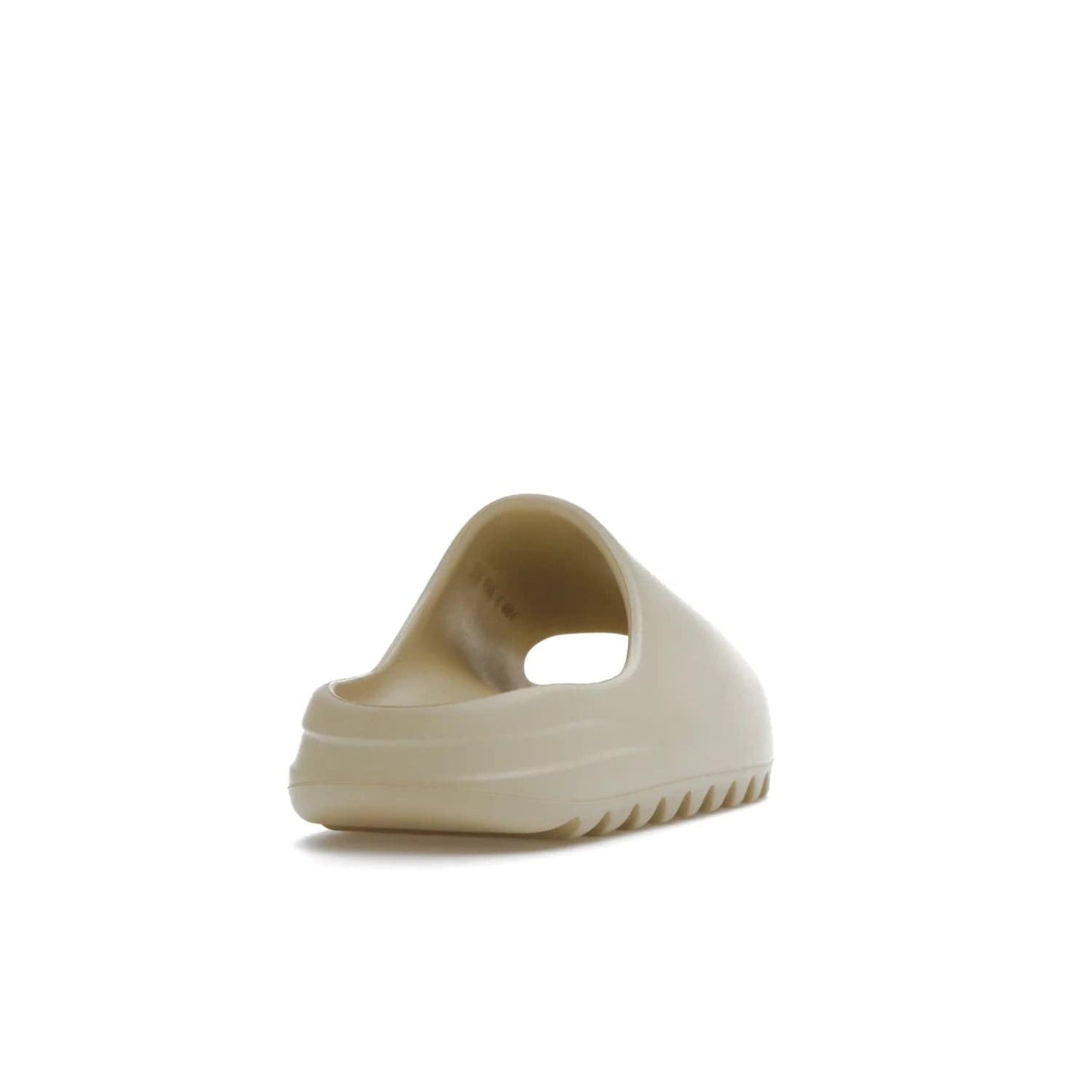 adidas Yeezy Slide Bone (2022 Restock) - Image 30 - Only at www.BallersClubKickz.com - Stay comfy with the adidas Yeezy Slide Bone - a fashionable silhouette with all-day comfort. This Bone/Bone/Bone colorway combines style and comfort with a pebbled texture and grooved sole. Restocked in May 2022, this shoe is the perfect addition to your collection.