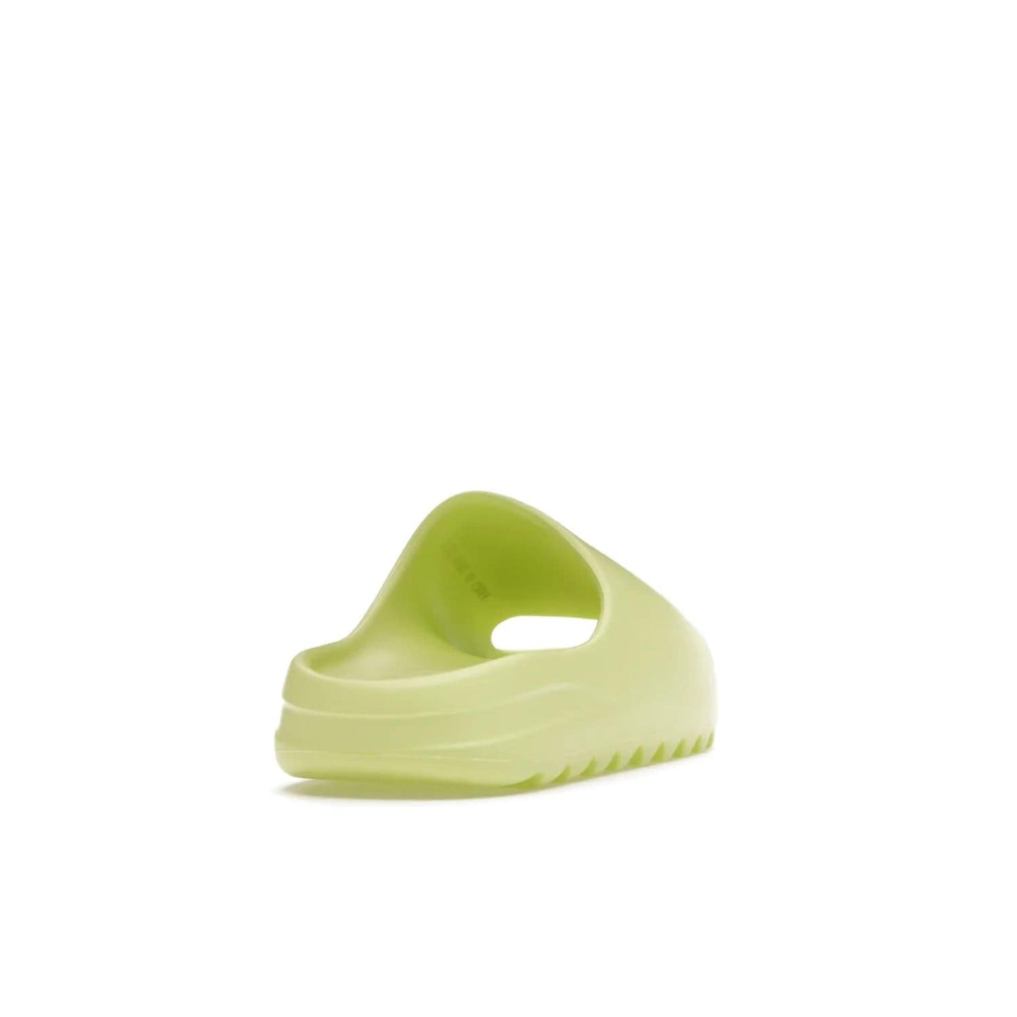adidas Yeezy Slide Glow Green - Image 30 - Only at www.BallersClubKickz.com - Experience an unexpected summer style with the adidas Yeezy Slide Glow Green. This limited edition slide sandal provides a lightweight and durable construction and a bold Glow Green hue. Strategic grooves enhance traction and provide all-day comfort. Make a statement with the adidas Yeezy Slide Glow Green.