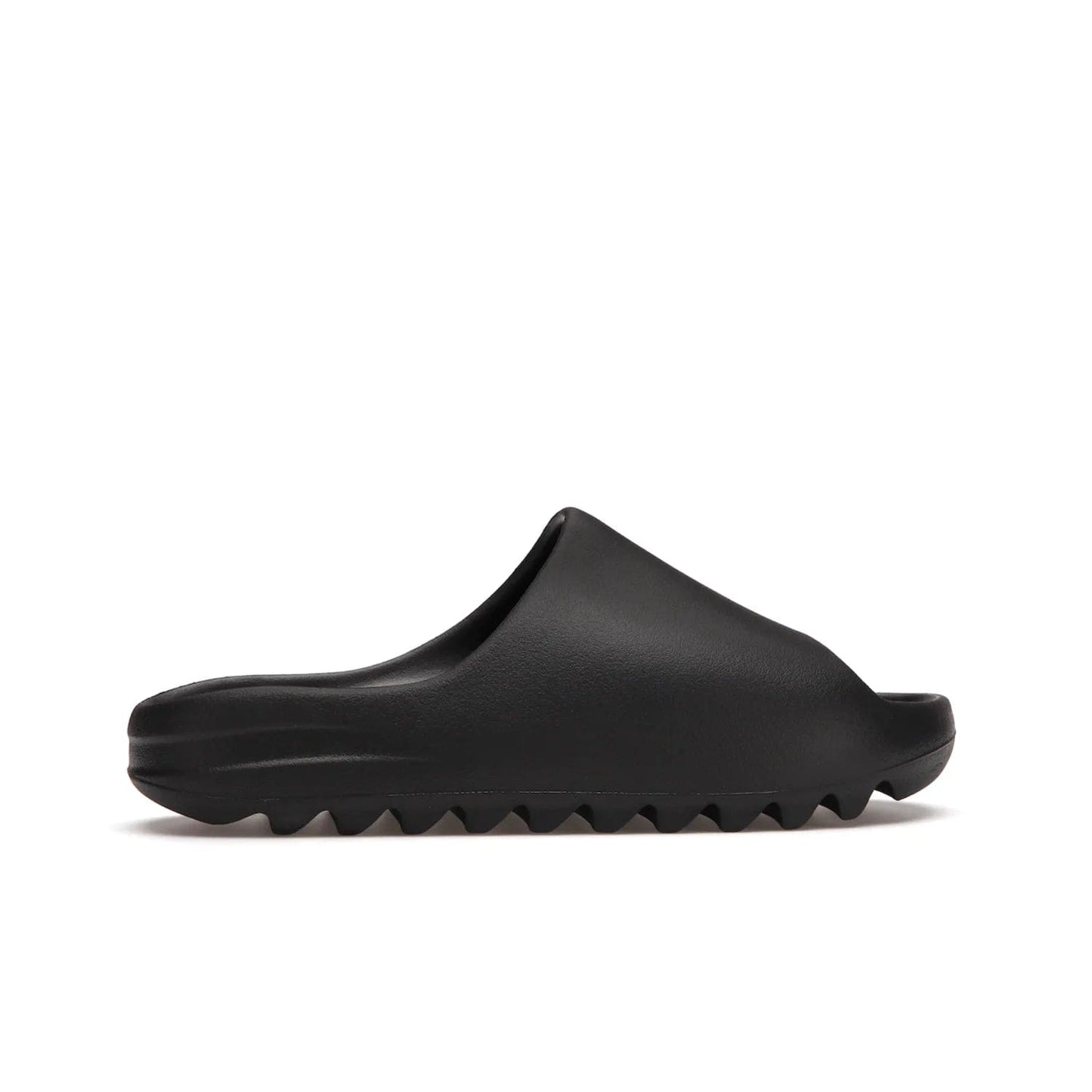 adidas Yeezy Slide Onyx - Image 36 - Only at www.BallersClubKickz.com - Step into comfort and style with the adidas Yeezy Slide Onyx. Featuring foam construction, an all-black colorway and a grooved outsole for stability and responsiveness, this versatile slide is a must-have for your collection.
