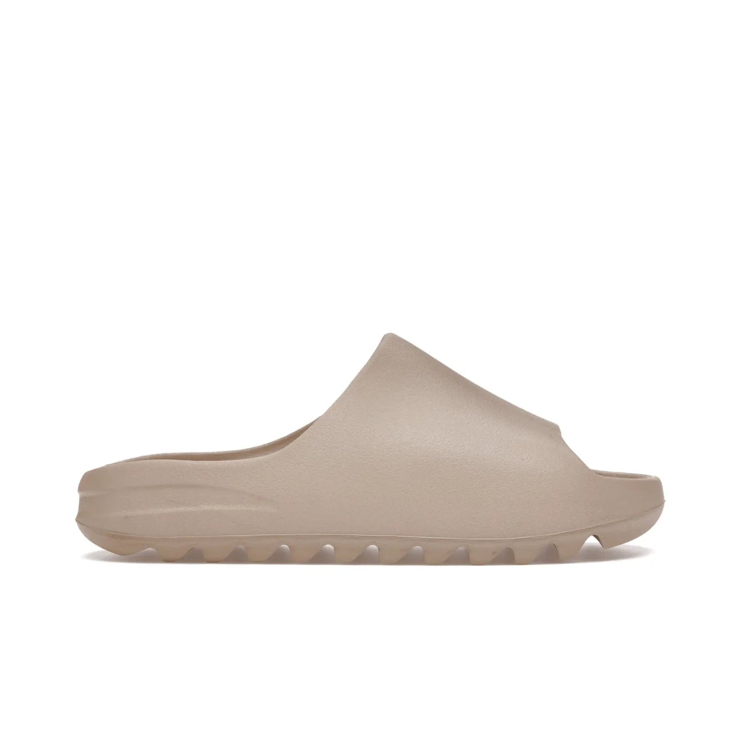 adidas Yeezy Slide Pure (Restock Pair) - Image 1 - Only at www.BallersClubKickz.com - Experience comfort and style with the adidas Yeezy Slide Pure (Restock Pair)! Featuring a pebbled composition and a grooved sole and cushioned footbed, this is the perfect shoe to pair with jeans or joggers. Get ready for the classic Pure/Pure/Pure colorway!
