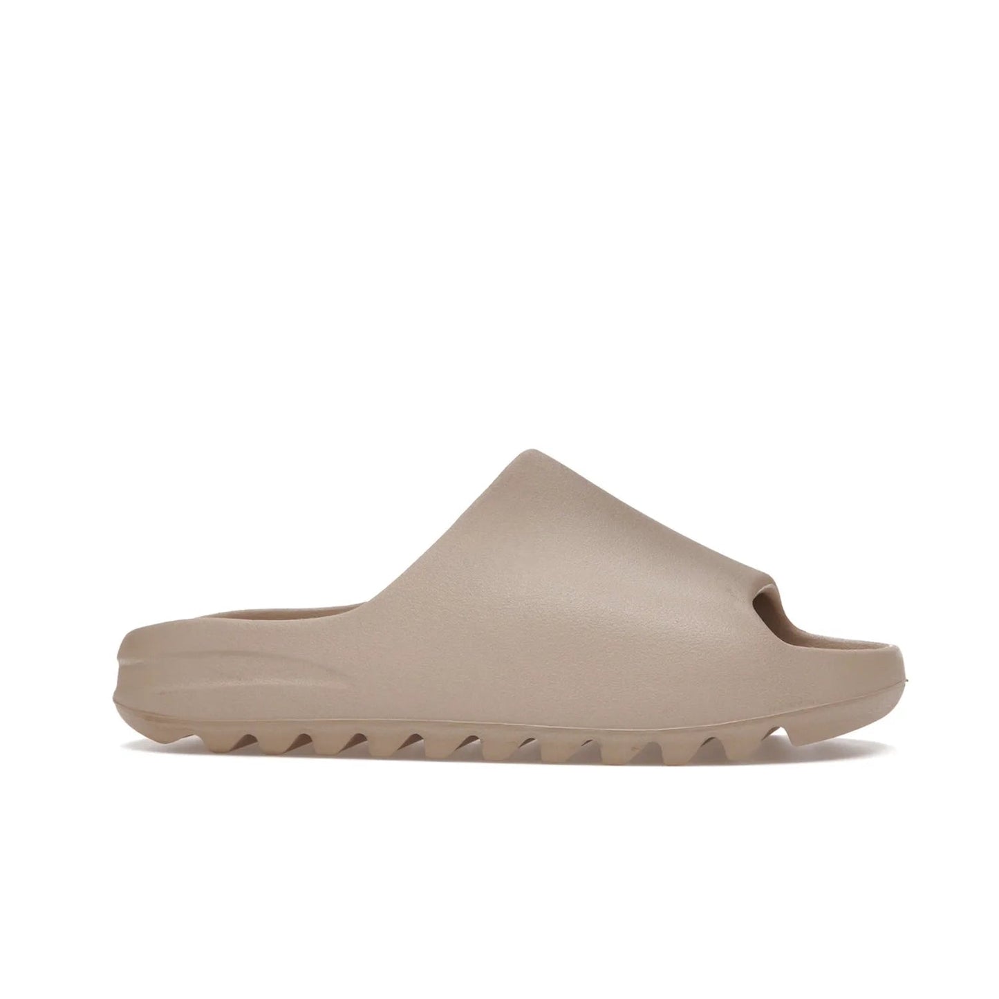 adidas Yeezy Slide Pure (Restock Pair) - Image 2 - Only at www.BallersClubKickz.com - Experience comfort and style with the adidas Yeezy Slide Pure (Restock Pair)! Featuring a pebbled composition and a grooved sole and cushioned footbed, this is the perfect shoe to pair with jeans or joggers. Get ready for the classic Pure/Pure/Pure colorway!