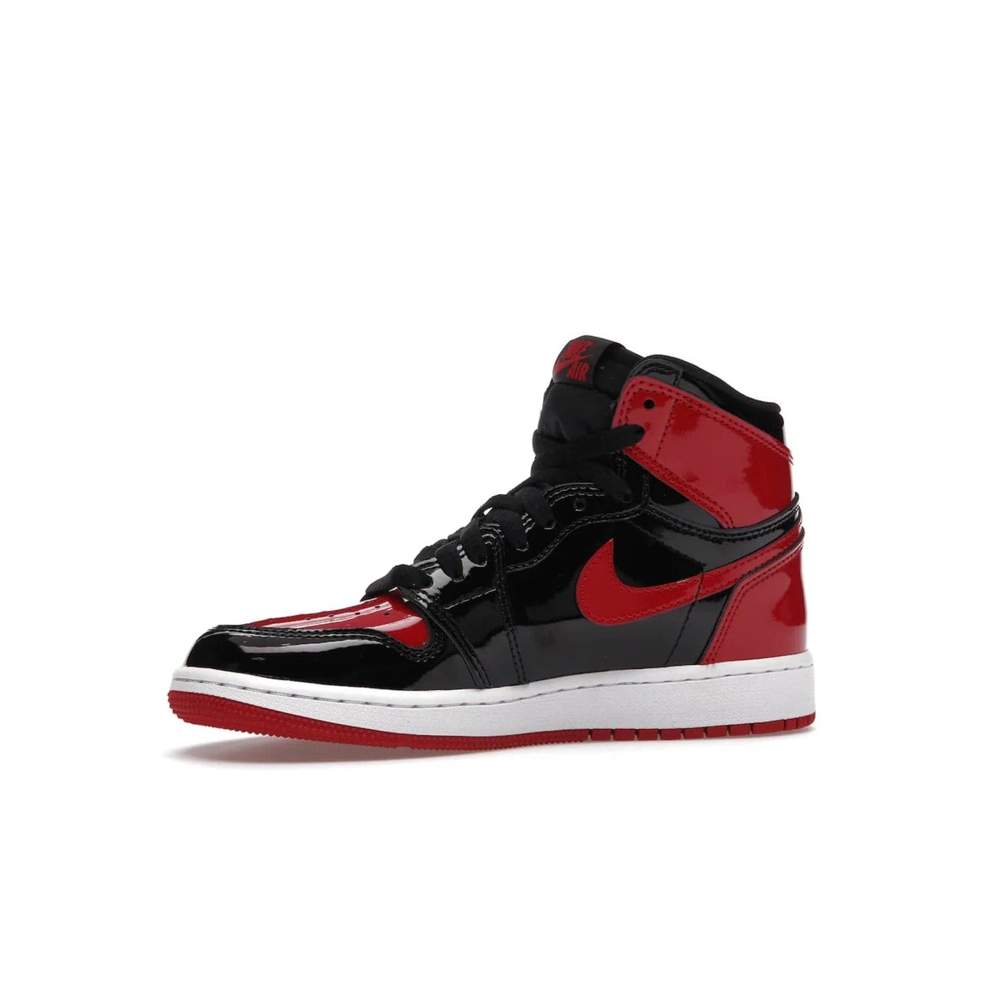Jordan 1 Retro High OG Patent Bred (GS) - Image 17 - Only at www.BallersClubKickz.com - Upgrade your sneaker game with the iconic Air Jordan 1 Retro High OG Bred Patent GS. Crafted with premium patent leather and basketball-inspired details for a classic look, they also feature an encapsulated Air-sole cushioning and enhanced red rubber outsole. Don't miss this timeless sneaker with a striking black, white, and varsity red colorway, dropping December 2021.