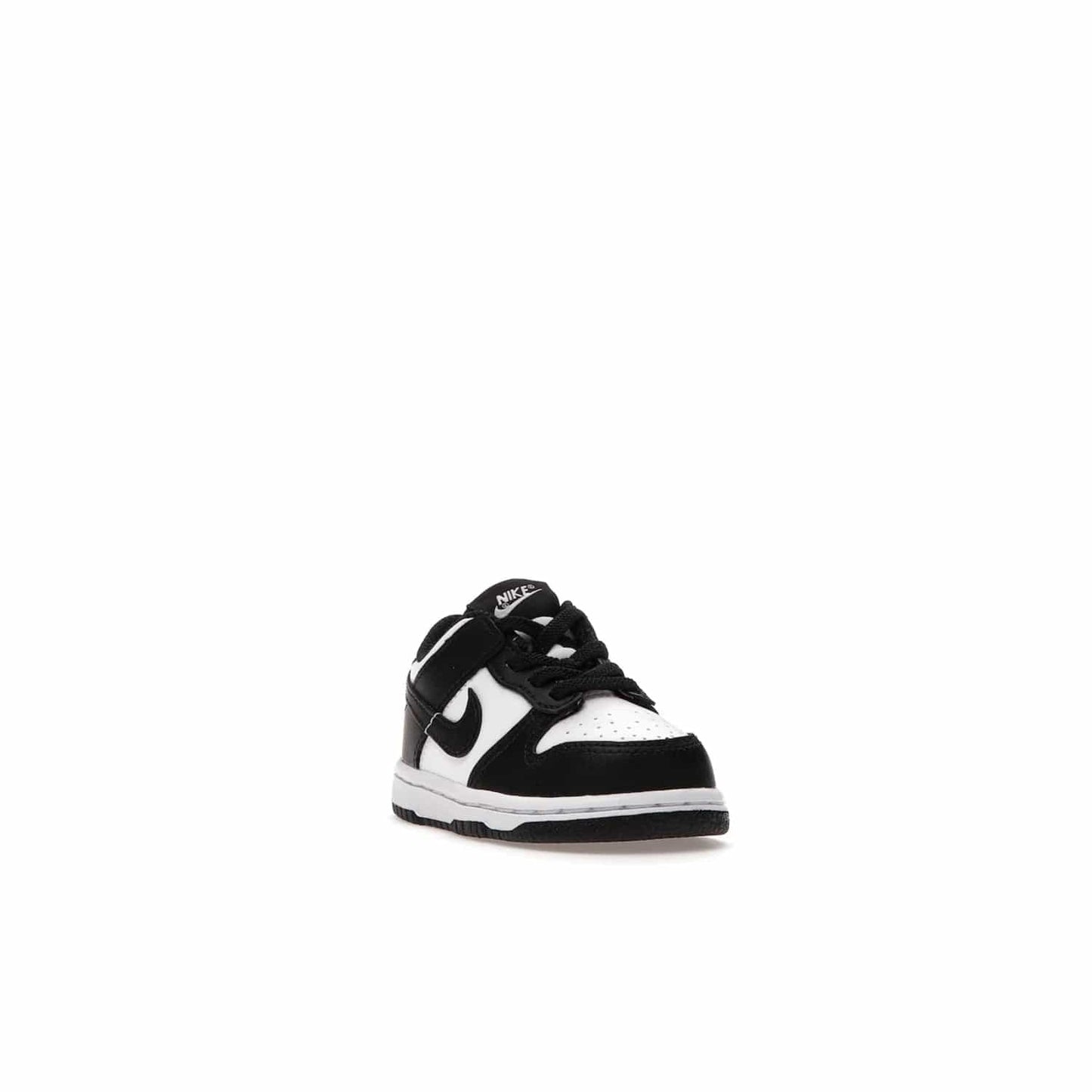 Nike Dunk Low Retro White Black Panda (2021) (TD) - Image 7 - Only at www.BallersClubKickz.com - The perfect blend of classic style and modern style, the Nike Dunk Low Retro White Black (TD) toddler shoe has a soft leather upper, white midsole, and black outsole. Signature Swoosh branding and lightly padded tongue give it timeless Nike style. Released in March 2021.