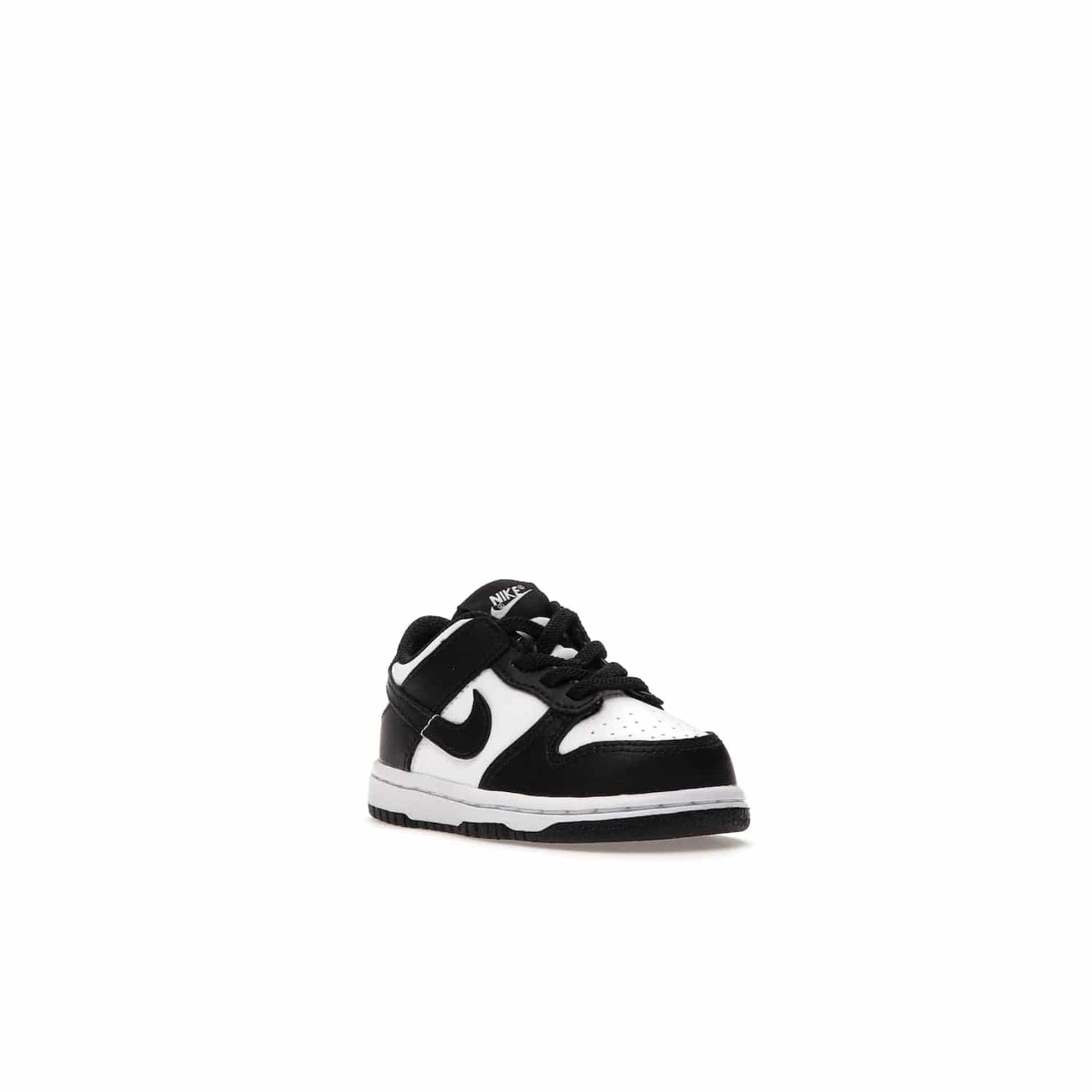 Nike Dunk Low Retro White Black Panda (2021) (TD) - Image 6 - Only at www.BallersClubKickz.com - The perfect blend of classic style and modern style, the Nike Dunk Low Retro White Black (TD) toddler shoe has a soft leather upper, white midsole, and black outsole. Signature Swoosh branding and lightly padded tongue give it timeless Nike style. Released in March 2021.