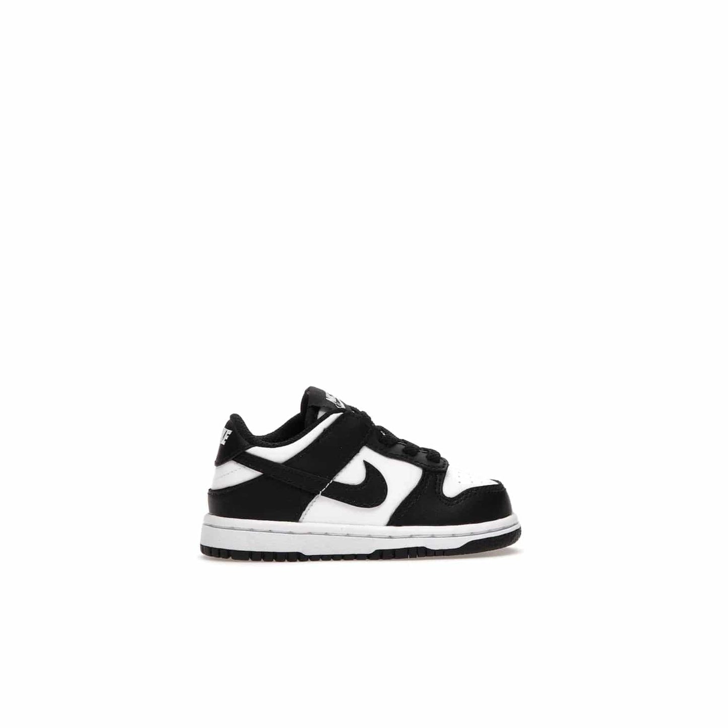 Nike Dunk Low Retro White Black Panda (2021) (TD) - Image 36 - Only at www.BallersClubKickz.com - The perfect blend of classic style and modern style, the Nike Dunk Low Retro White Black (TD) toddler shoe has a soft leather upper, white midsole, and black outsole. Signature Swoosh branding and lightly padded tongue give it timeless Nike style. Released in March 2021.
