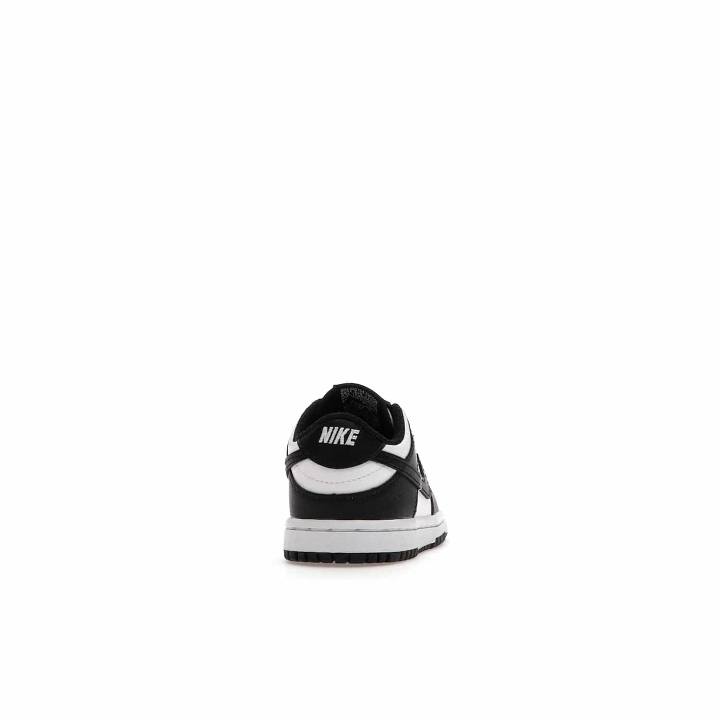 Nike Dunk Low Retro White Black Panda (2021) (TD) - Image 29 - Only at www.BallersClubKickz.com - The perfect blend of classic style and modern style, the Nike Dunk Low Retro White Black (TD) toddler shoe has a soft leather upper, white midsole, and black outsole. Signature Swoosh branding and lightly padded tongue give it timeless Nike style. Released in March 2021.