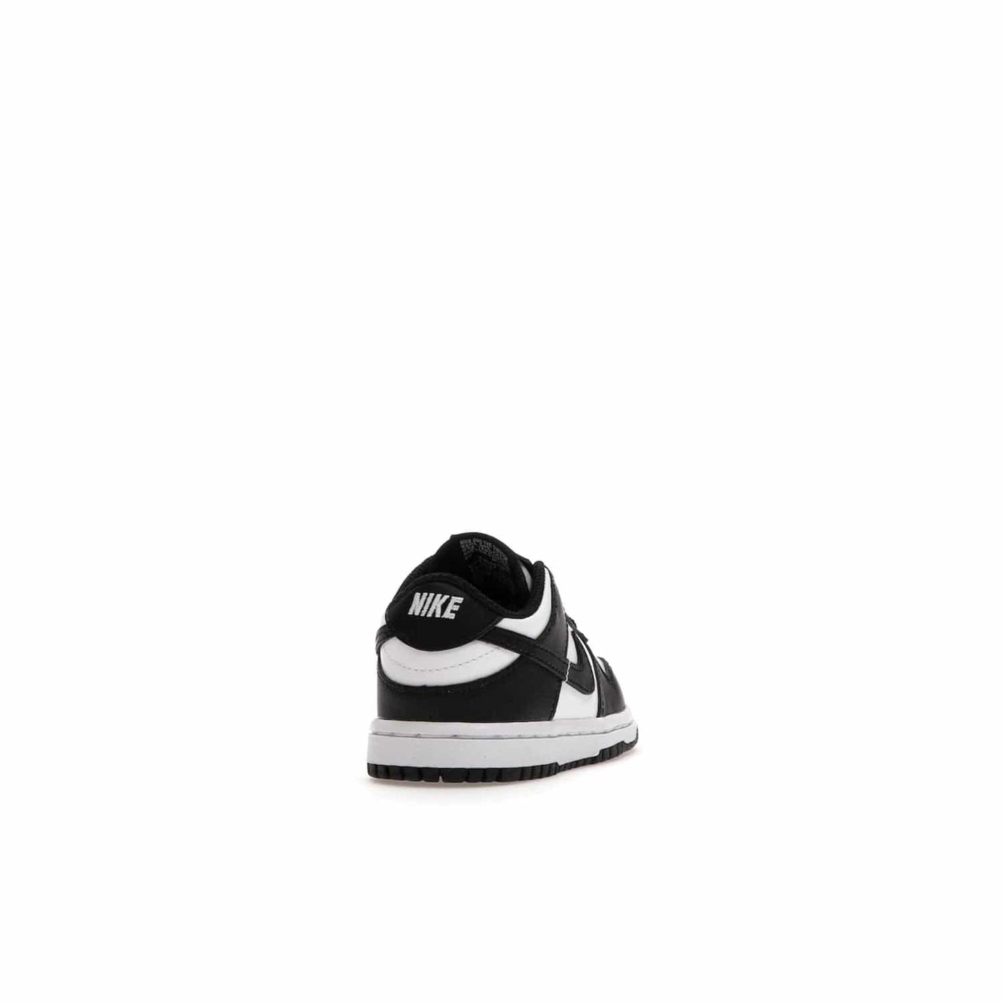 Nike Dunk Low Retro White Black Panda (2021) (TD) - Image 30 - Only at www.BallersClubKickz.com - The perfect blend of classic style and modern style, the Nike Dunk Low Retro White Black (TD) toddler shoe has a soft leather upper, white midsole, and black outsole. Signature Swoosh branding and lightly padded tongue give it timeless Nike style. Released in March 2021.