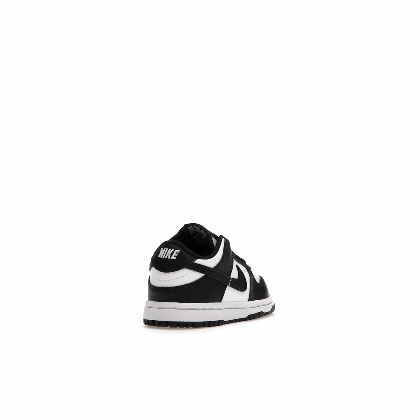 Nike Dunk Low Retro White Black Panda (2021) (TD) - Image 31 - Only at www.BallersClubKickz.com - The perfect blend of classic style and modern style, the Nike Dunk Low Retro White Black (TD) toddler shoe has a soft leather upper, white midsole, and black outsole. Signature Swoosh branding and lightly padded tongue give it timeless Nike style. Released in March 2021.