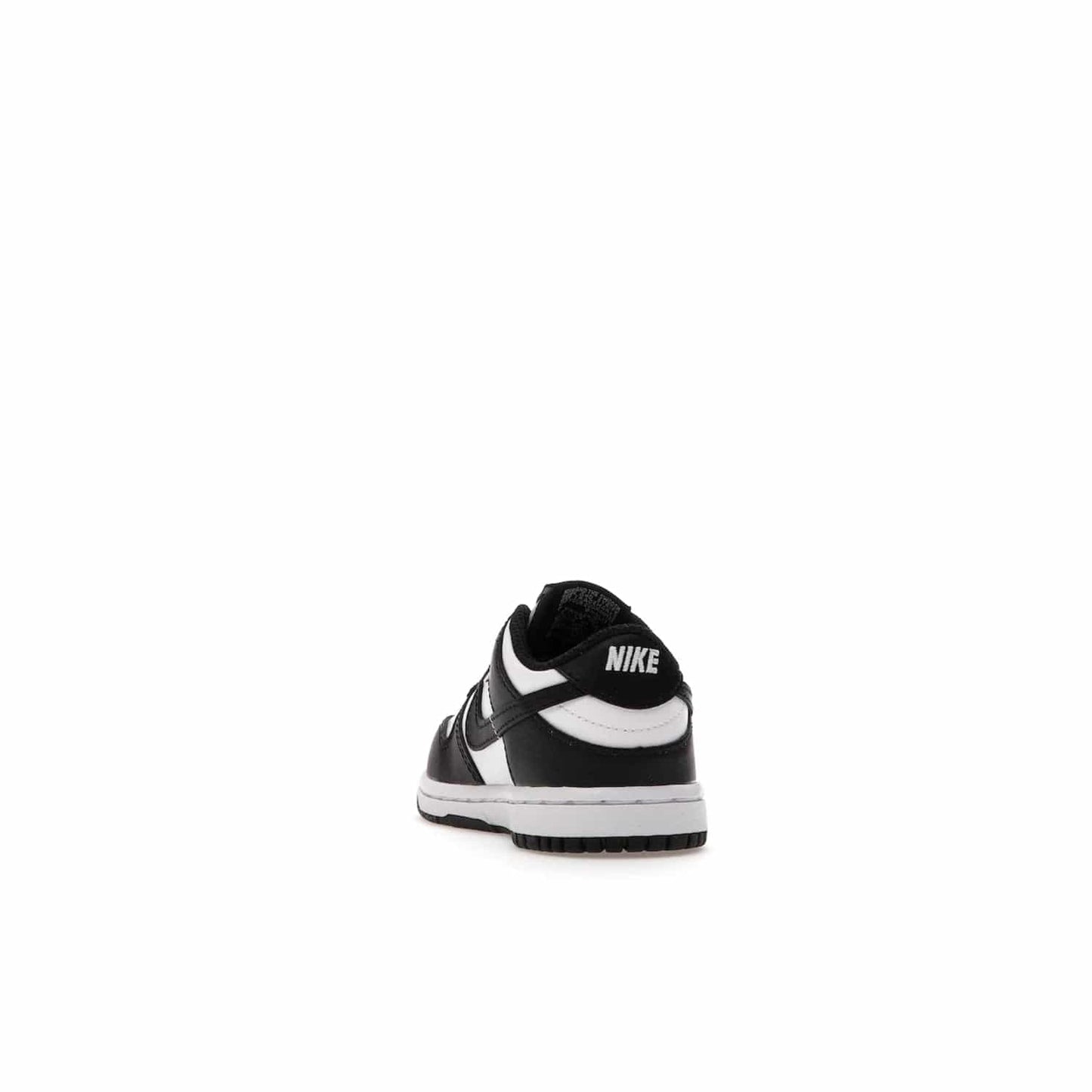 Nike Dunk Low Retro White Black Panda (2021) (TD) - Image 26 - Only at www.BallersClubKickz.com - The perfect blend of classic style and modern style, the Nike Dunk Low Retro White Black (TD) toddler shoe has a soft leather upper, white midsole, and black outsole. Signature Swoosh branding and lightly padded tongue give it timeless Nike style. Released in March 2021.