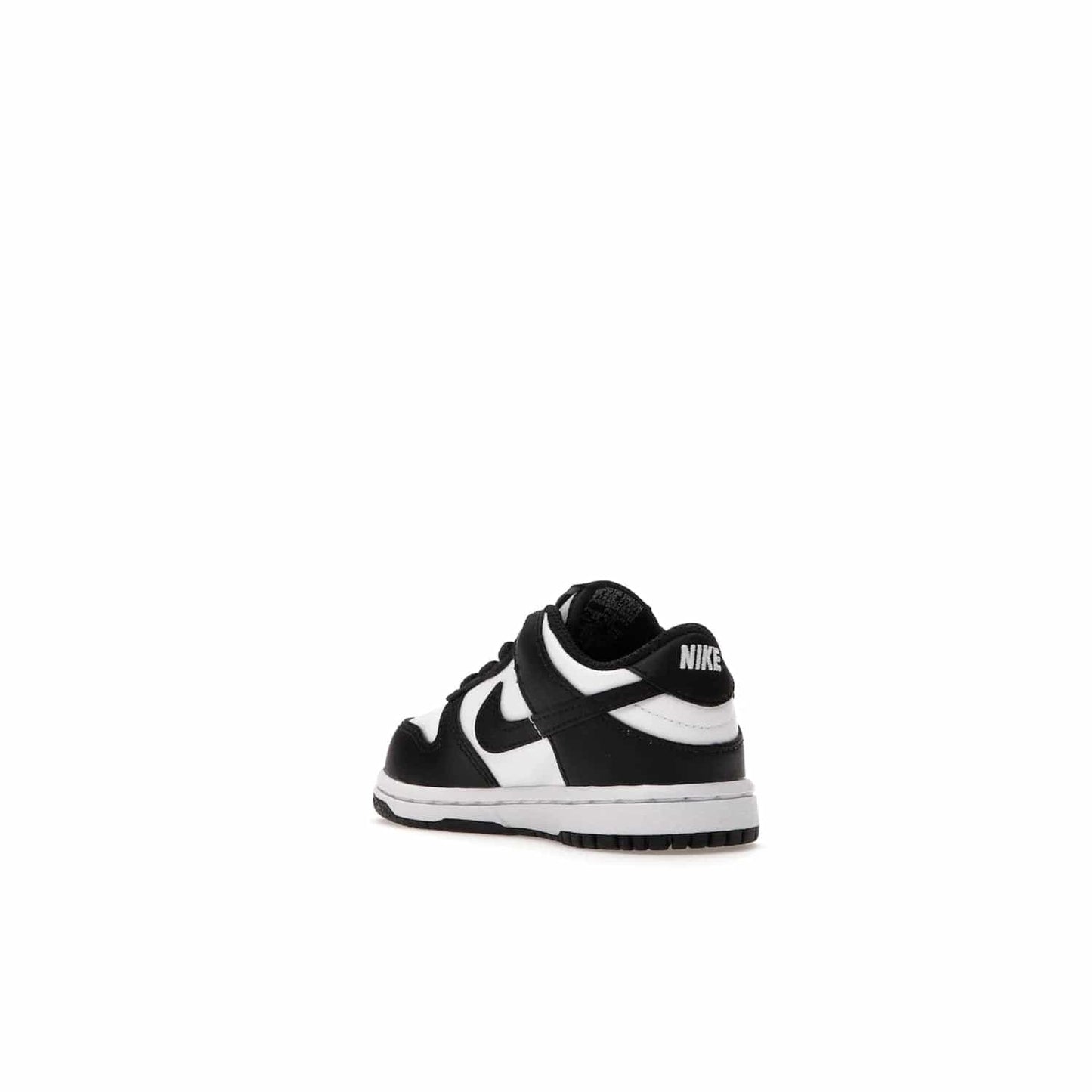 Nike Dunk Low Retro White Black Panda (2021) (TD) - Image 24 - Only at www.BallersClubKickz.com - The perfect blend of classic style and modern style, the Nike Dunk Low Retro White Black (TD) toddler shoe has a soft leather upper, white midsole, and black outsole. Signature Swoosh branding and lightly padded tongue give it timeless Nike style. Released in March 2021.