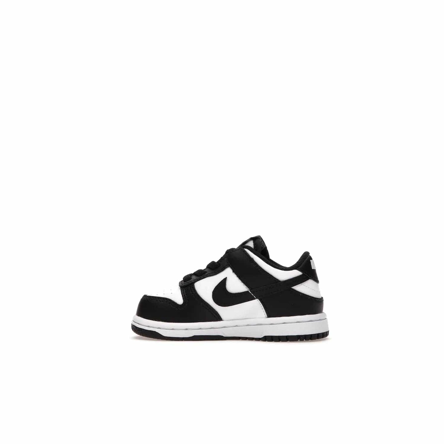 Nike Dunk Low Retro White Black Panda (2021) (TD) - Image 20 - Only at www.BallersClubKickz.com - The perfect blend of classic style and modern style, the Nike Dunk Low Retro White Black (TD) toddler shoe has a soft leather upper, white midsole, and black outsole. Signature Swoosh branding and lightly padded tongue give it timeless Nike style. Released in March 2021.