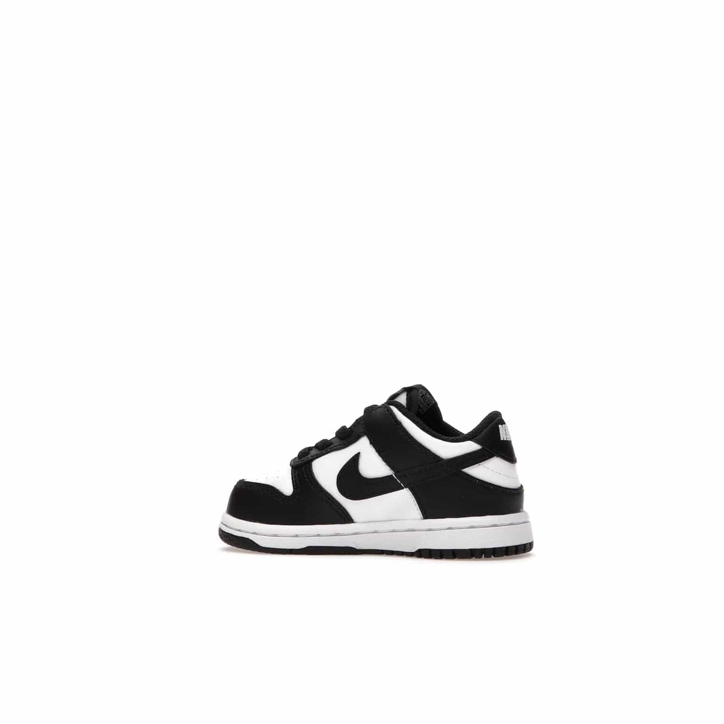 Nike Dunk Low Retro White Black Panda (2021) (TD) - Image 21 - Only at www.BallersClubKickz.com - The perfect blend of classic style and modern style, the Nike Dunk Low Retro White Black (TD) toddler shoe has a soft leather upper, white midsole, and black outsole. Signature Swoosh branding and lightly padded tongue give it timeless Nike style. Released in March 2021.