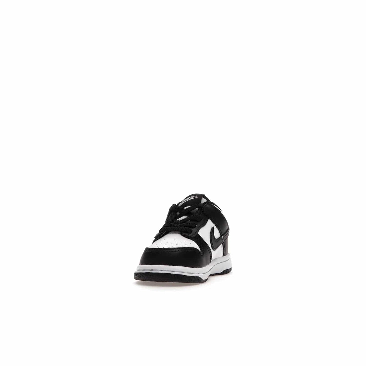 Nike Dunk Low Retro White Black Panda (2021) (TD) - Image 12 - Only at www.BallersClubKickz.com - The perfect blend of classic style and modern style, the Nike Dunk Low Retro White Black (TD) toddler shoe has a soft leather upper, white midsole, and black outsole. Signature Swoosh branding and lightly padded tongue give it timeless Nike style. Released in March 2021.