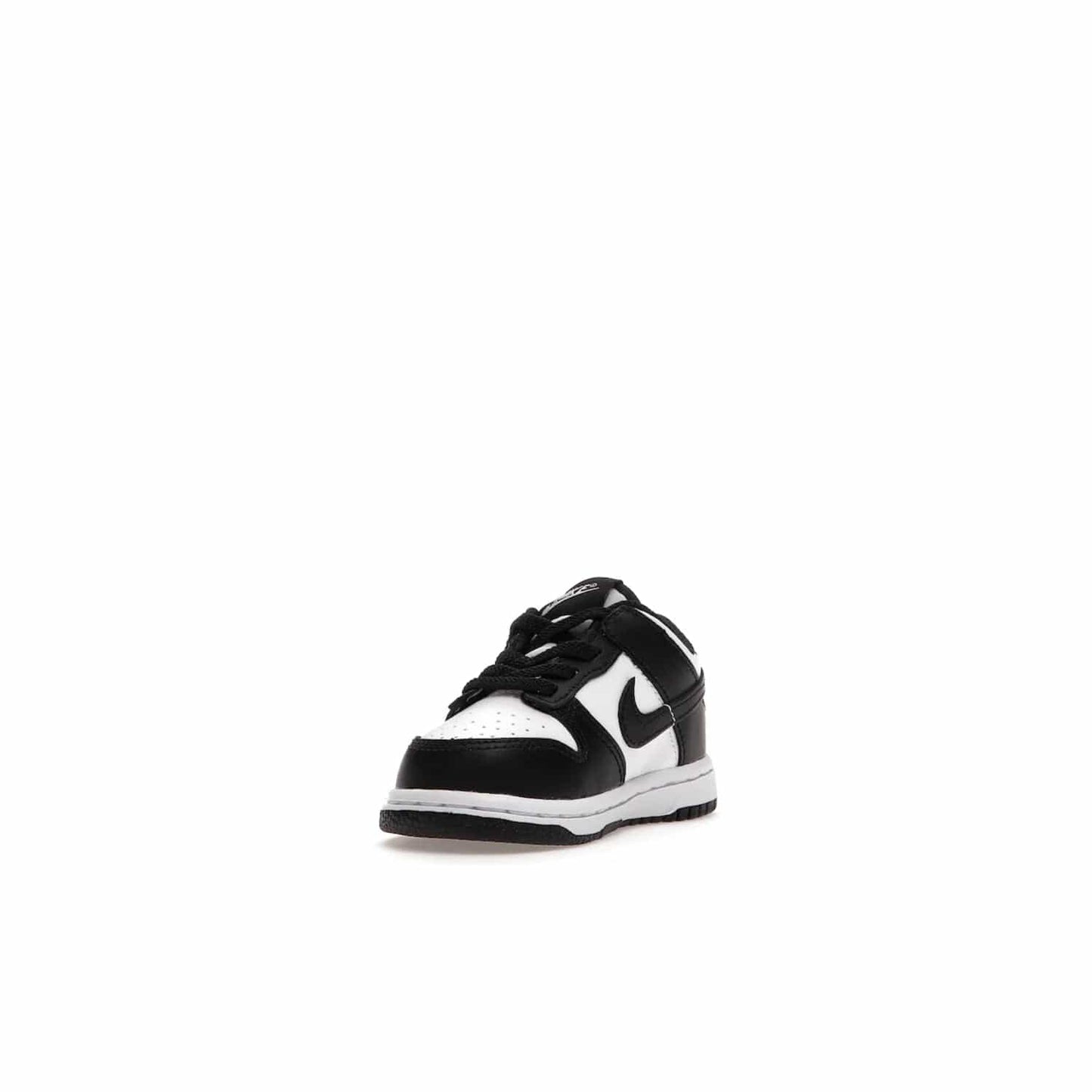 Nike Dunk Low Retro White Black Panda (2021) (TD) - Image 13 - Only at www.BallersClubKickz.com - The perfect blend of classic style and modern style, the Nike Dunk Low Retro White Black (TD) toddler shoe has a soft leather upper, white midsole, and black outsole. Signature Swoosh branding and lightly padded tongue give it timeless Nike style. Released in March 2021.