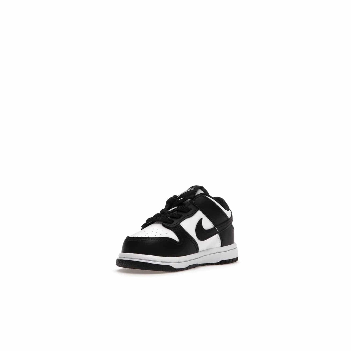 Nike Dunk Low Retro White Black Panda (2021) (TD) - Image 14 - Only at www.BallersClubKickz.com - The perfect blend of classic style and modern style, the Nike Dunk Low Retro White Black (TD) toddler shoe has a soft leather upper, white midsole, and black outsole. Signature Swoosh branding and lightly padded tongue give it timeless Nike style. Released in March 2021.