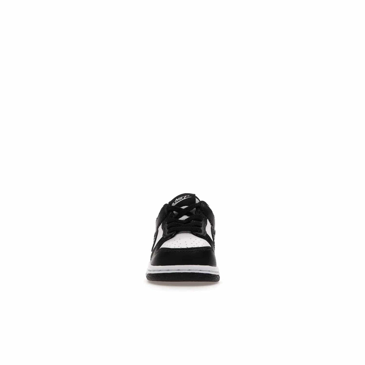 Nike Dunk Low Retro White Black Panda (2021) (TD) - Image 10 - Only at www.BallersClubKickz.com - The perfect blend of classic style and modern style, the Nike Dunk Low Retro White Black (TD) toddler shoe has a soft leather upper, white midsole, and black outsole. Signature Swoosh branding and lightly padded tongue give it timeless Nike style. Released in March 2021.