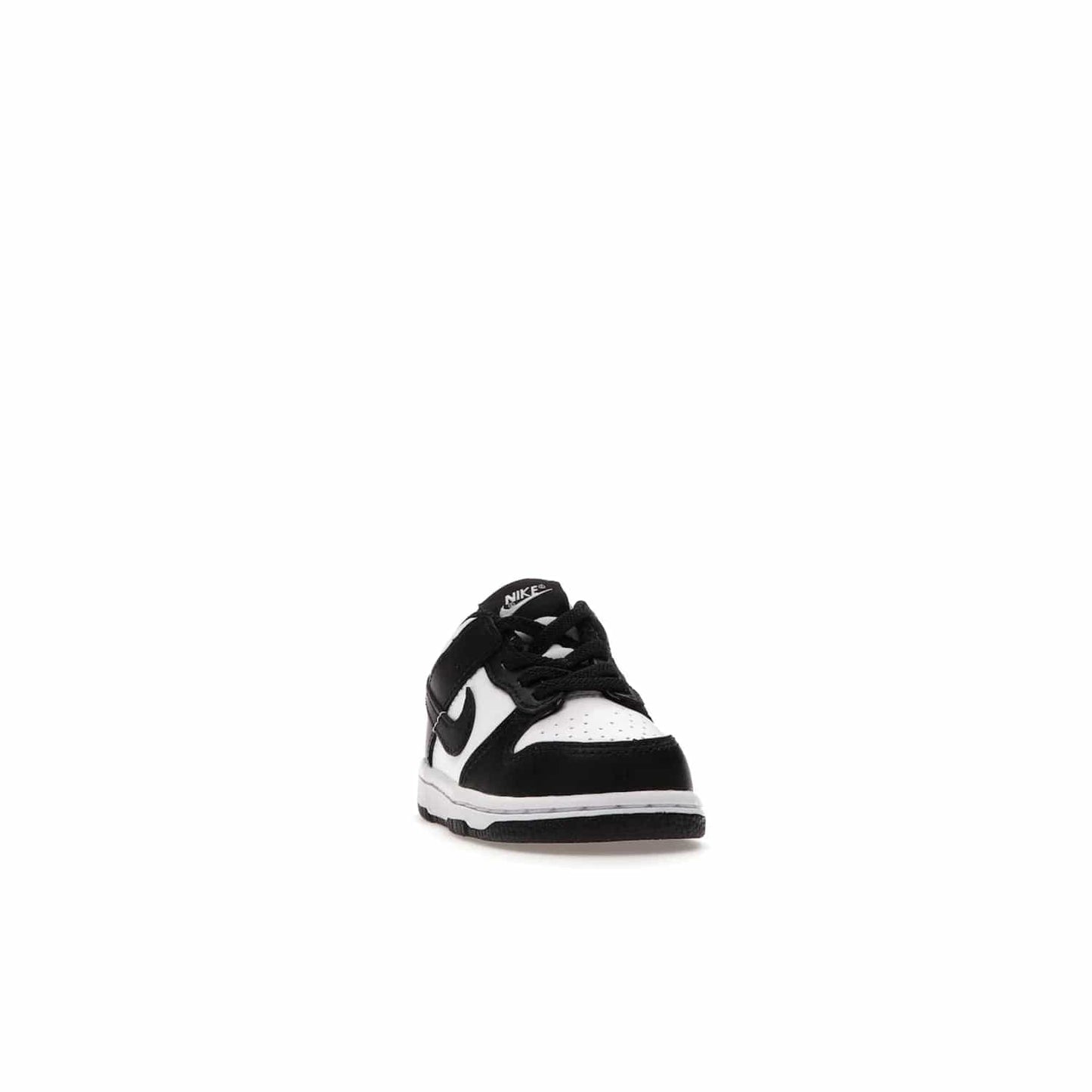 Nike Dunk Low Retro White Black Panda (2021) (TD) - Image 8 - Only at www.BallersClubKickz.com - The perfect blend of classic style and modern style, the Nike Dunk Low Retro White Black (TD) toddler shoe has a soft leather upper, white midsole, and black outsole. Signature Swoosh branding and lightly padded tongue give it timeless Nike style. Released in March 2021.