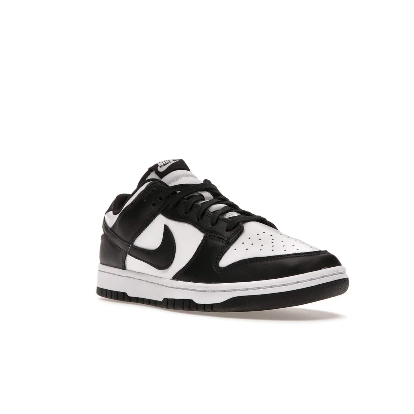 Nike Dunk Low Retro White Black Panda (2021) - Image 6 - Only at www.BallersClubKickz.com - Shop the Nike Dunk Low Retro White Black for classic styling featuring white leather with black leather overlays and classic Nike branding. Released in 2021, this timeless design offers a white midsole and black outsole for a stylish look. Shop all the Nike Dunks & rock this classic look.