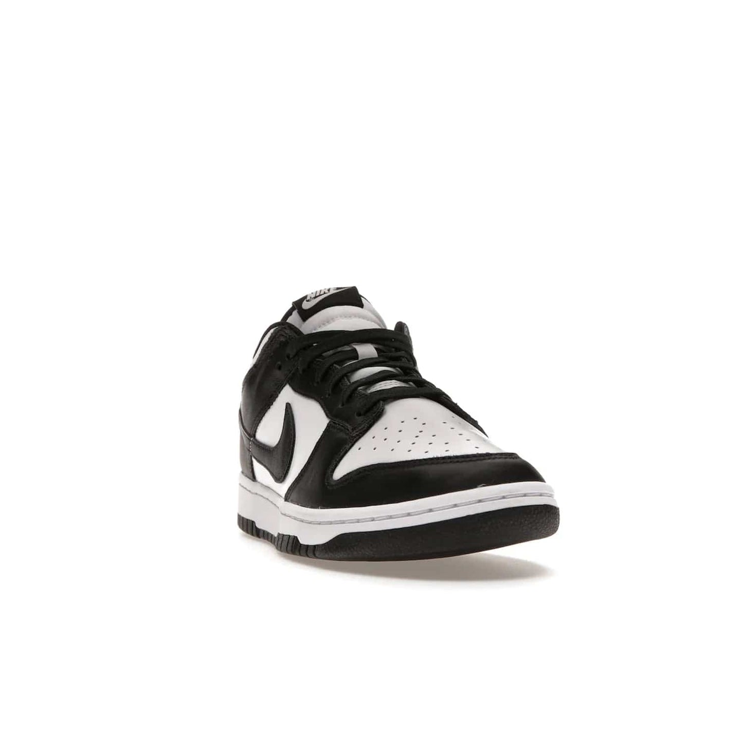 Nike Dunk Low Retro White Black Panda (2021) - Image 8 - Only at www.BallersClubKickz.com - Shop the Nike Dunk Low Retro White Black for classic styling featuring white leather with black leather overlays and classic Nike branding. Released in 2021, this timeless design offers a white midsole and black outsole for a stylish look. Shop all the Nike Dunks & rock this classic look.