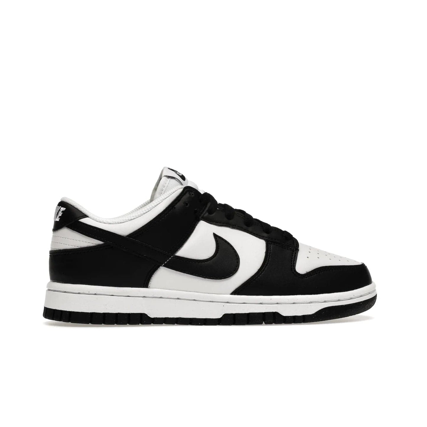 Nike Dunk Low Next Nature White Black Panda (Women's) - Image 36 - Only at www.BallersClubKickz.com - Experience sustainable fashion with the Women's Nike Dunk Low Next Nature White Black. Made with 50% recycled materials, this shoe offers a two-tone black and white Flyleather upper, matching soles and woven tongue labels. Available in November 2021.