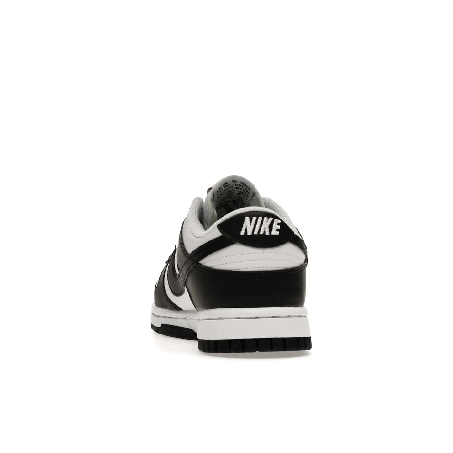 Nike Dunk Low Next Nature White Black Panda (Women's) - Image 27 - Only at www.BallersClubKickz.com - Experience sustainable fashion with the Women's Nike Dunk Low Next Nature White Black. Made with 50% recycled materials, this shoe offers a two-tone black and white Flyleather upper, matching soles and woven tongue labels. Available in November 2021.