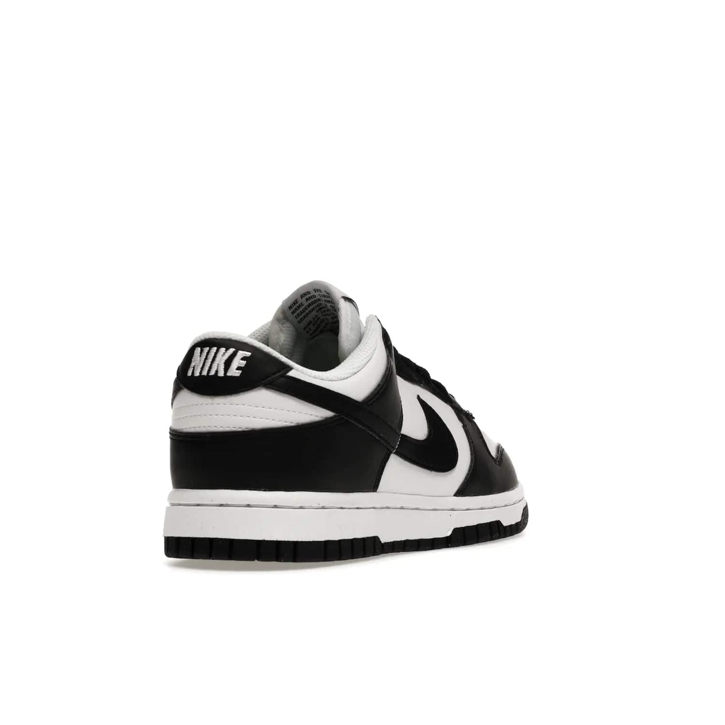 Nike Dunk Low Next Nature White Black Panda (Women's) - Image 31 - Only at www.BallersClubKickz.com - Experience sustainable fashion with the Women's Nike Dunk Low Next Nature White Black. Made with 50% recycled materials, this shoe offers a two-tone black and white Flyleather upper, matching soles and woven tongue labels. Available in November 2021.
