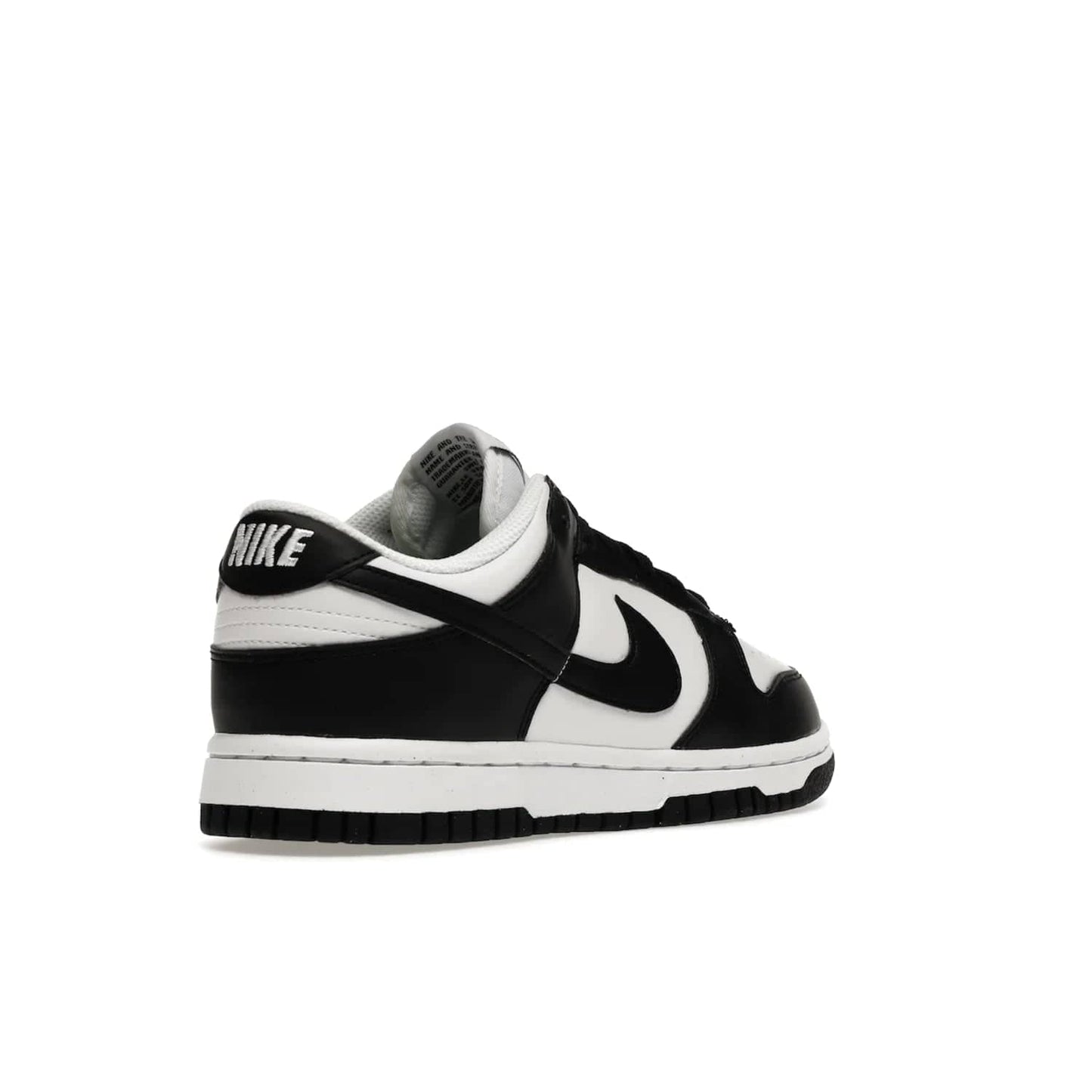 Nike Dunk Low Next Nature White Black Panda (Women's) - Image 32 - Only at www.BallersClubKickz.com - Experience sustainable fashion with the Women's Nike Dunk Low Next Nature White Black. Made with 50% recycled materials, this shoe offers a two-tone black and white Flyleather upper, matching soles and woven tongue labels. Available in November 2021.