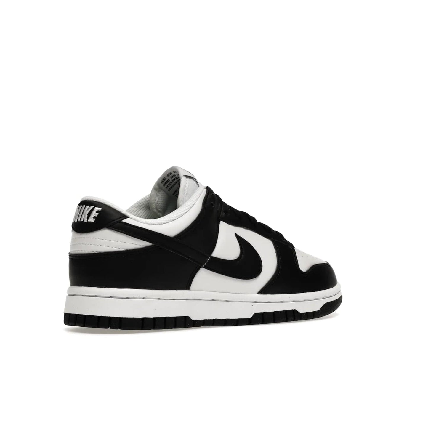 Nike Dunk Low Next Nature White Black Panda (Women's) - Image 33 - Only at www.BallersClubKickz.com - Experience sustainable fashion with the Women's Nike Dunk Low Next Nature White Black. Made with 50% recycled materials, this shoe offers a two-tone black and white Flyleather upper, matching soles and woven tongue labels. Available in November 2021.