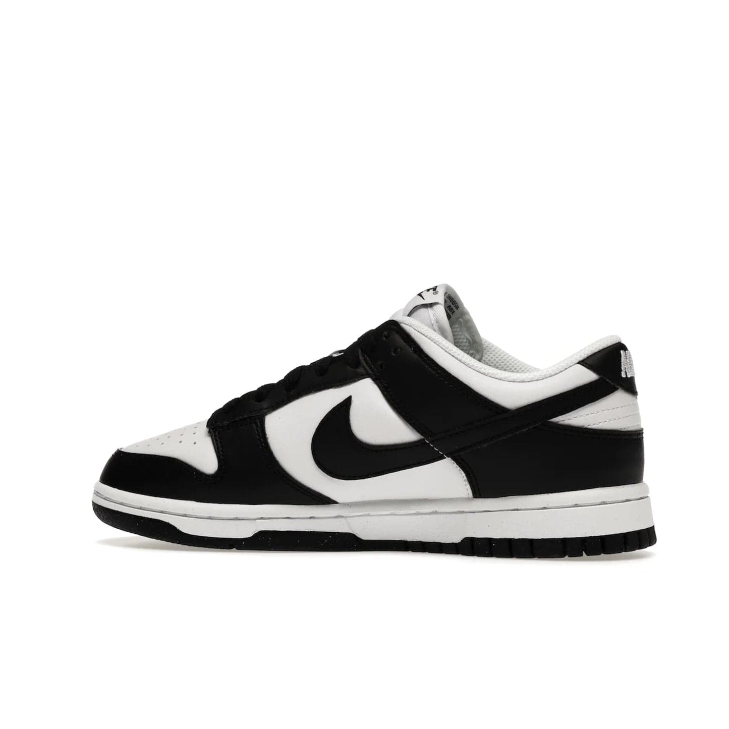 Nike Dunk Low Next Nature White Black Panda (Women's) - Image 21 - Only at www.BallersClubKickz.com - Experience sustainable fashion with the Women's Nike Dunk Low Next Nature White Black. Made with 50% recycled materials, this shoe offers a two-tone black and white Flyleather upper, matching soles and woven tongue labels. Available in November 2021.