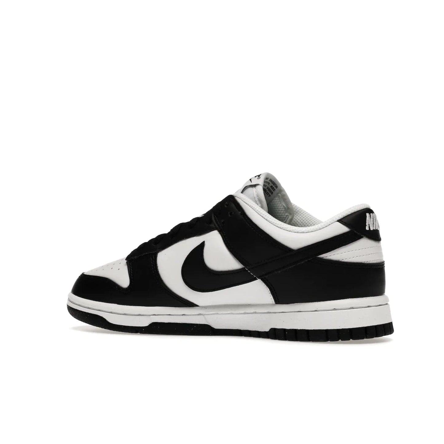 Nike Dunk Low Next Nature White Black Panda (Women's) - Image 22 - Only at www.BallersClubKickz.com - Experience sustainable fashion with the Women's Nike Dunk Low Next Nature White Black. Made with 50% recycled materials, this shoe offers a two-tone black and white Flyleather upper, matching soles and woven tongue labels. Available in November 2021.