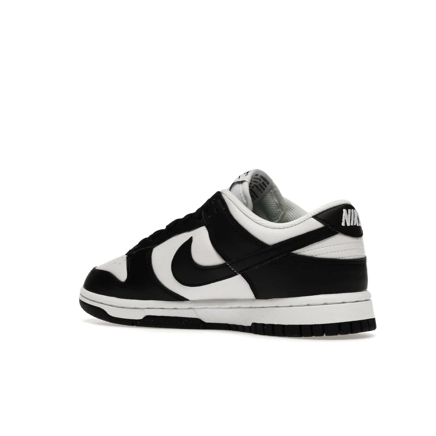 Nike Dunk Low Next Nature White Black Panda (Women's) - Image 23 - Only at www.BallersClubKickz.com - Experience sustainable fashion with the Women's Nike Dunk Low Next Nature White Black. Made with 50% recycled materials, this shoe offers a two-tone black and white Flyleather upper, matching soles and woven tongue labels. Available in November 2021.