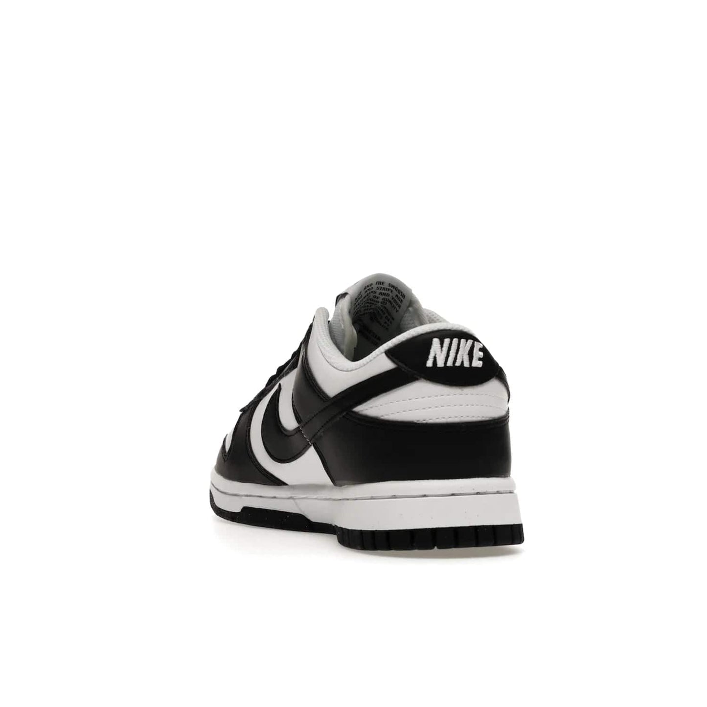 Nike Dunk Low Next Nature White Black Panda (Women's) - Image 26 - Only at www.BallersClubKickz.com - Experience sustainable fashion with the Women's Nike Dunk Low Next Nature White Black. Made with 50% recycled materials, this shoe offers a two-tone black and white Flyleather upper, matching soles and woven tongue labels. Available in November 2021.
