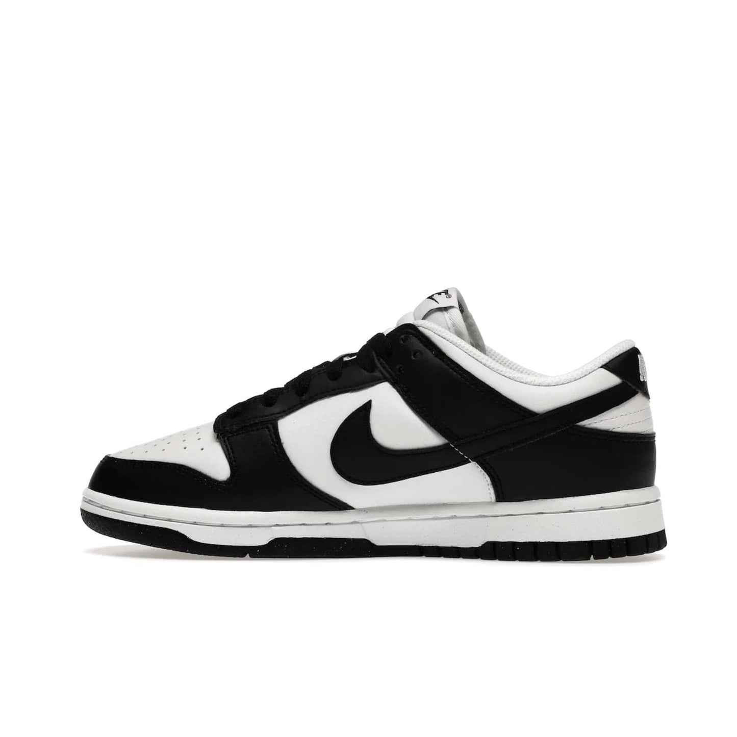 Nike Dunk Low Next Nature White Black Panda (Women's) - Image 20 - Only at www.BallersClubKickz.com - Experience sustainable fashion with the Women's Nike Dunk Low Next Nature White Black. Made with 50% recycled materials, this shoe offers a two-tone black and white Flyleather upper, matching soles and woven tongue labels. Available in November 2021.