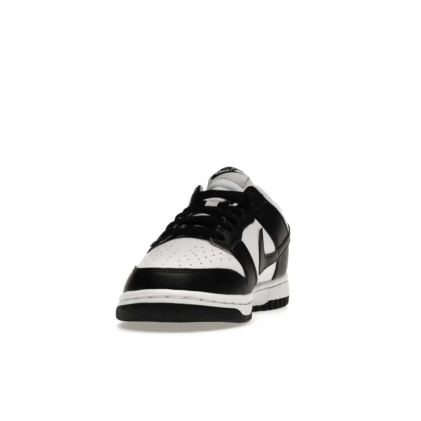 Nike Dunk Low Next Nature White Black Panda (Women's) - Image 12 - Only at www.BallersClubKickz.com - Experience sustainable fashion with the Women's Nike Dunk Low Next Nature White Black. Made with 50% recycled materials, this shoe offers a two-tone black and white Flyleather upper, matching soles and woven tongue labels. Available in November 2021.
