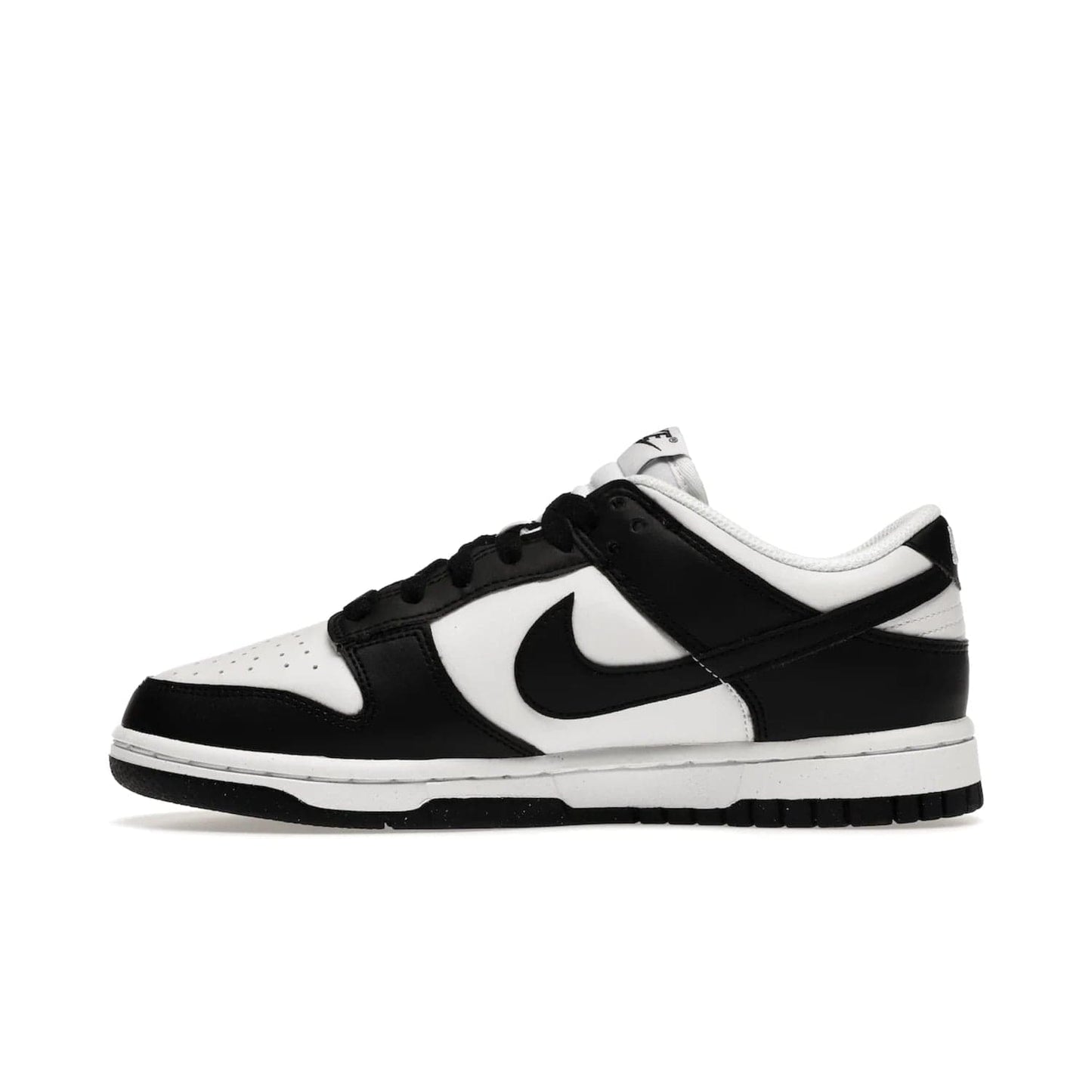 Nike Dunk Low Next Nature White Black Panda (Women's) - Image 19 - Only at www.BallersClubKickz.com - Experience sustainable fashion with the Women's Nike Dunk Low Next Nature White Black. Made with 50% recycled materials, this shoe offers a two-tone black and white Flyleather upper, matching soles and woven tongue labels. Available in November 2021.