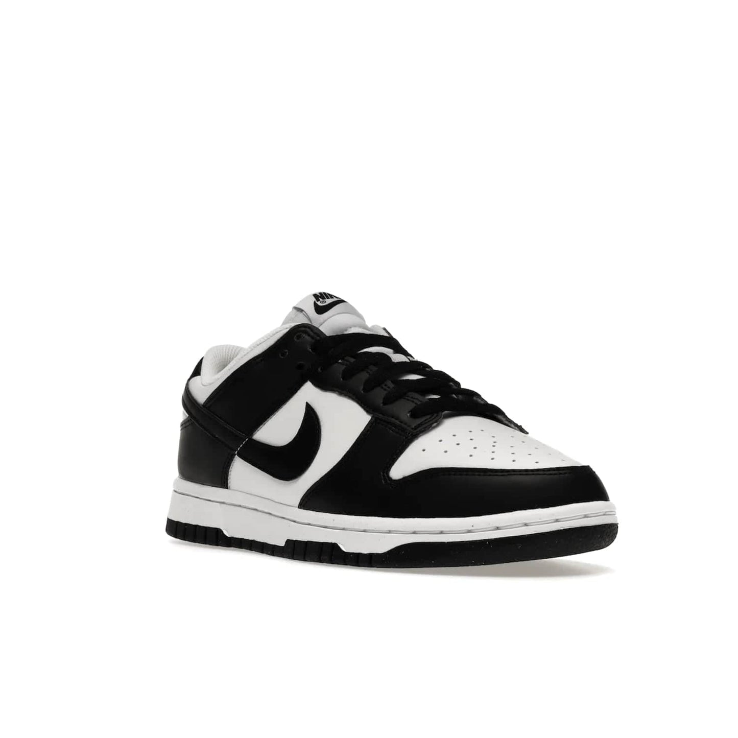 Nike Dunk Low Next Nature White Black Panda (Women's) - Image 6 - Only at www.BallersClubKickz.com - Experience sustainable fashion with the Women's Nike Dunk Low Next Nature White Black. Made with 50% recycled materials, this shoe offers a two-tone black and white Flyleather upper, matching soles and woven tongue labels. Available in November 2021.