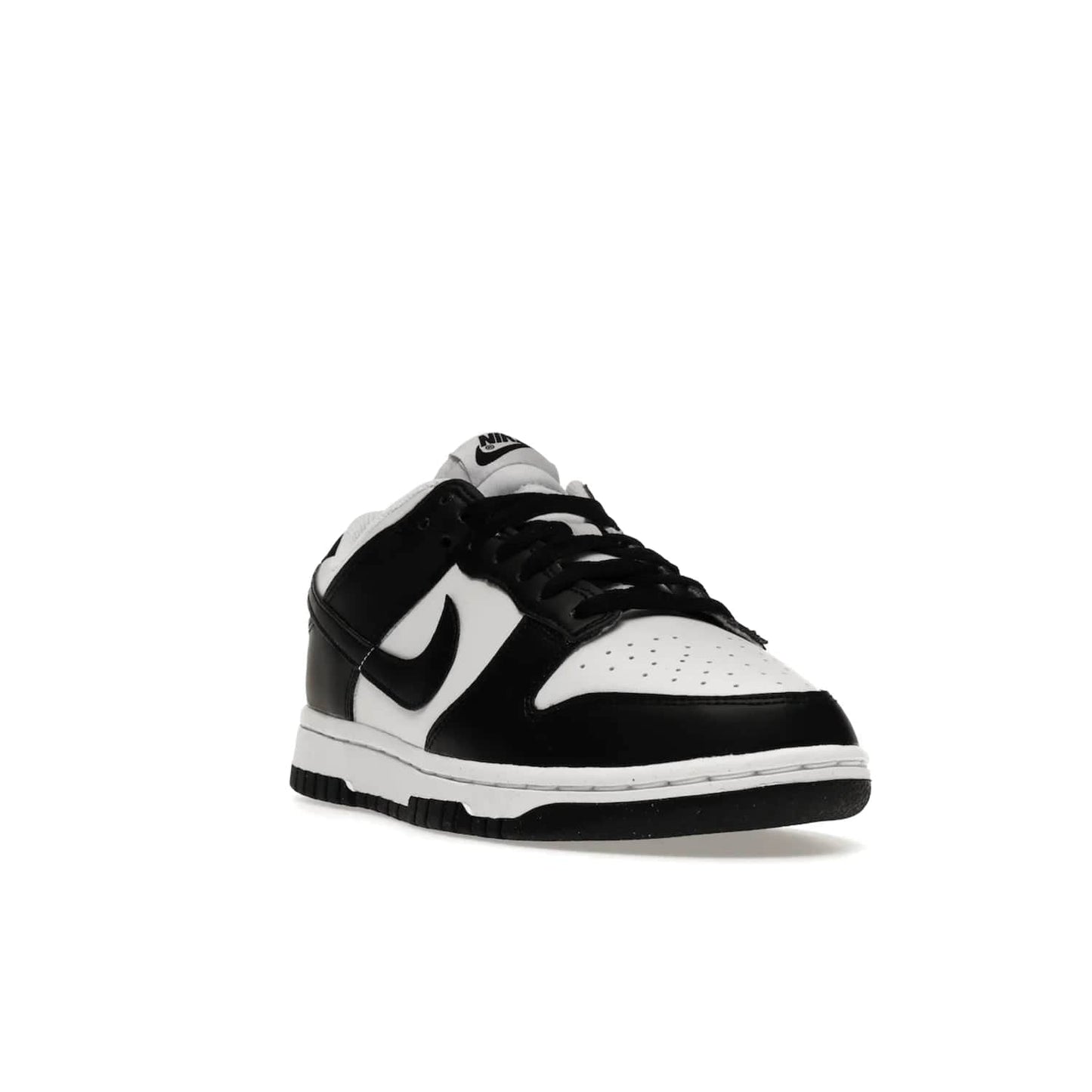 Nike Dunk Low Next Nature White Black Panda (Women's) - Image 7 - Only at www.BallersClubKickz.com - Experience sustainable fashion with the Women's Nike Dunk Low Next Nature White Black. Made with 50% recycled materials, this shoe offers a two-tone black and white Flyleather upper, matching soles and woven tongue labels. Available in November 2021.