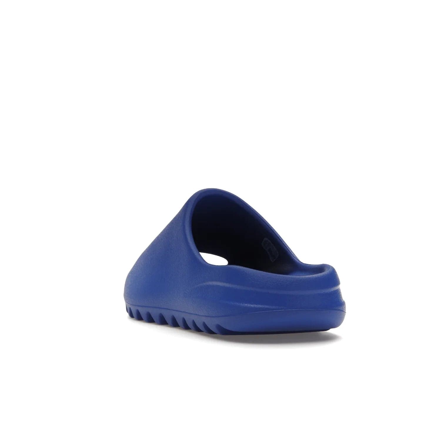 adidas Yeezy Slide Azure - Image 26 - Only at www.BallersClubKickz.com - Elevate your look with the adidas Yeezy Slide Azure. Boasting a vibrant hue for a unique style, this EVA foam slide is a statement of fearlessness and stylish expression. Step out with confidence knowing you're wearing more than a slide.
