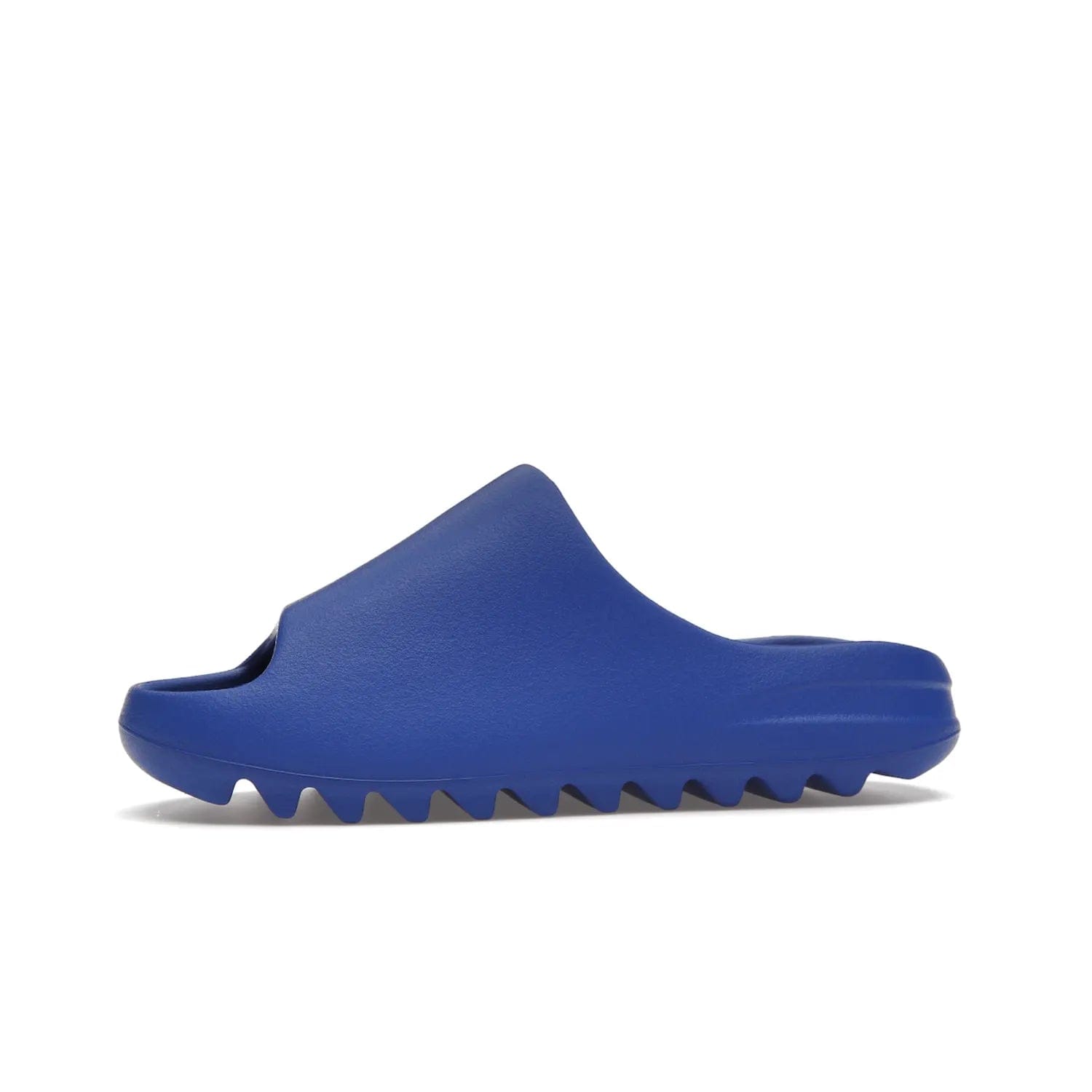 adidas Yeezy Slide Azure - Image 18 - Only at www.BallersClubKickz.com - Elevate your look with the adidas Yeezy Slide Azure. Boasting a vibrant hue for a unique style, this EVA foam slide is a statement of fearlessness and stylish expression. Step out with confidence knowing you're wearing more than a slide.
