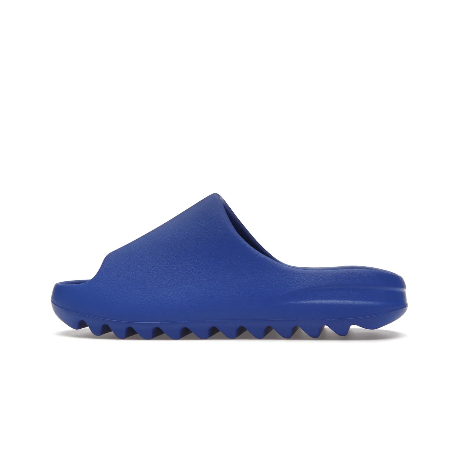 adidas Yeezy Slide Azure - Image 20 - Only at www.BallersClubKickz.com - Elevate your look with the adidas Yeezy Slide Azure. Boasting a vibrant hue for a unique style, this EVA foam slide is a statement of fearlessness and stylish expression. Step out with confidence knowing you're wearing more than a slide.