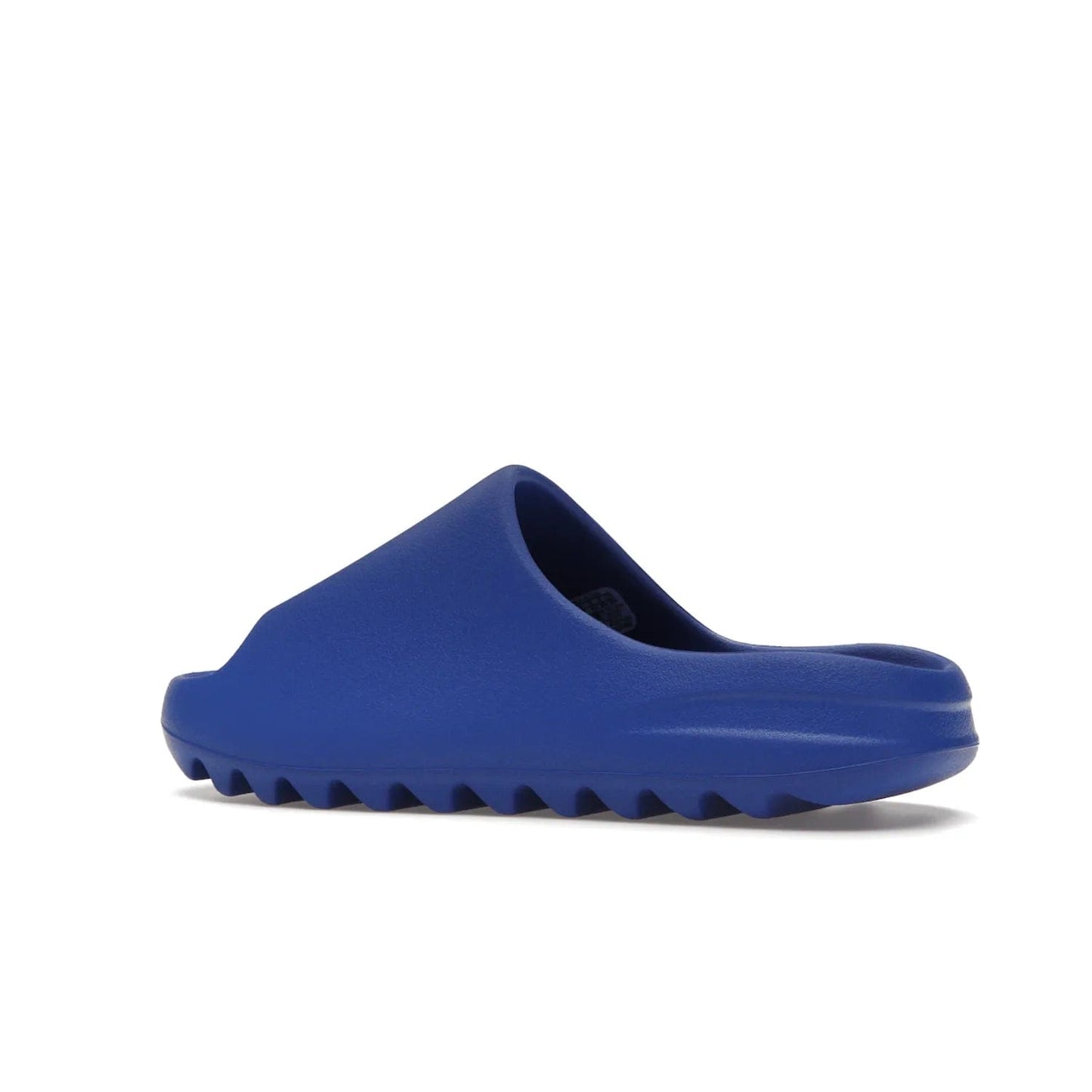 adidas Yeezy Slide Azure - Image 22 - Only at www.BallersClubKickz.com - Elevate your look with the adidas Yeezy Slide Azure. Boasting a vibrant hue for a unique style, this EVA foam slide is a statement of fearlessness and stylish expression. Step out with confidence knowing you're wearing more than a slide.