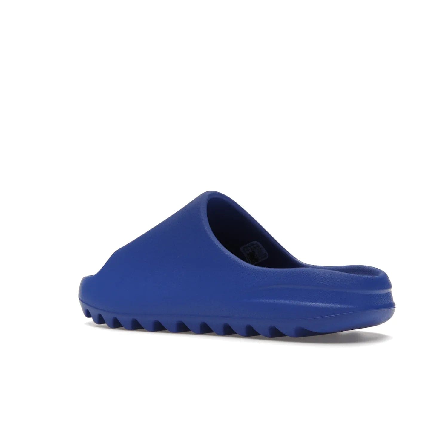 adidas Yeezy Slide Azure - Image 23 - Only at www.BallersClubKickz.com - Elevate your look with the adidas Yeezy Slide Azure. Boasting a vibrant hue for a unique style, this EVA foam slide is a statement of fearlessness and stylish expression. Step out with confidence knowing you're wearing more than a slide.