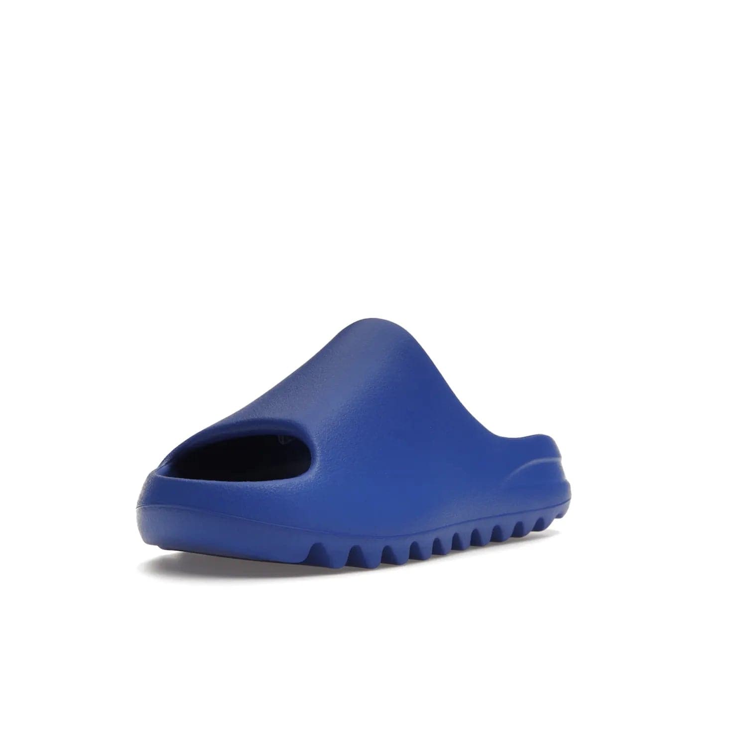 adidas Yeezy Slide Azure - Image 14 - Only at www.BallersClubKickz.com - Elevate your look with the adidas Yeezy Slide Azure. Boasting a vibrant hue for a unique style, this EVA foam slide is a statement of fearlessness and stylish expression. Step out with confidence knowing you're wearing more than a slide.