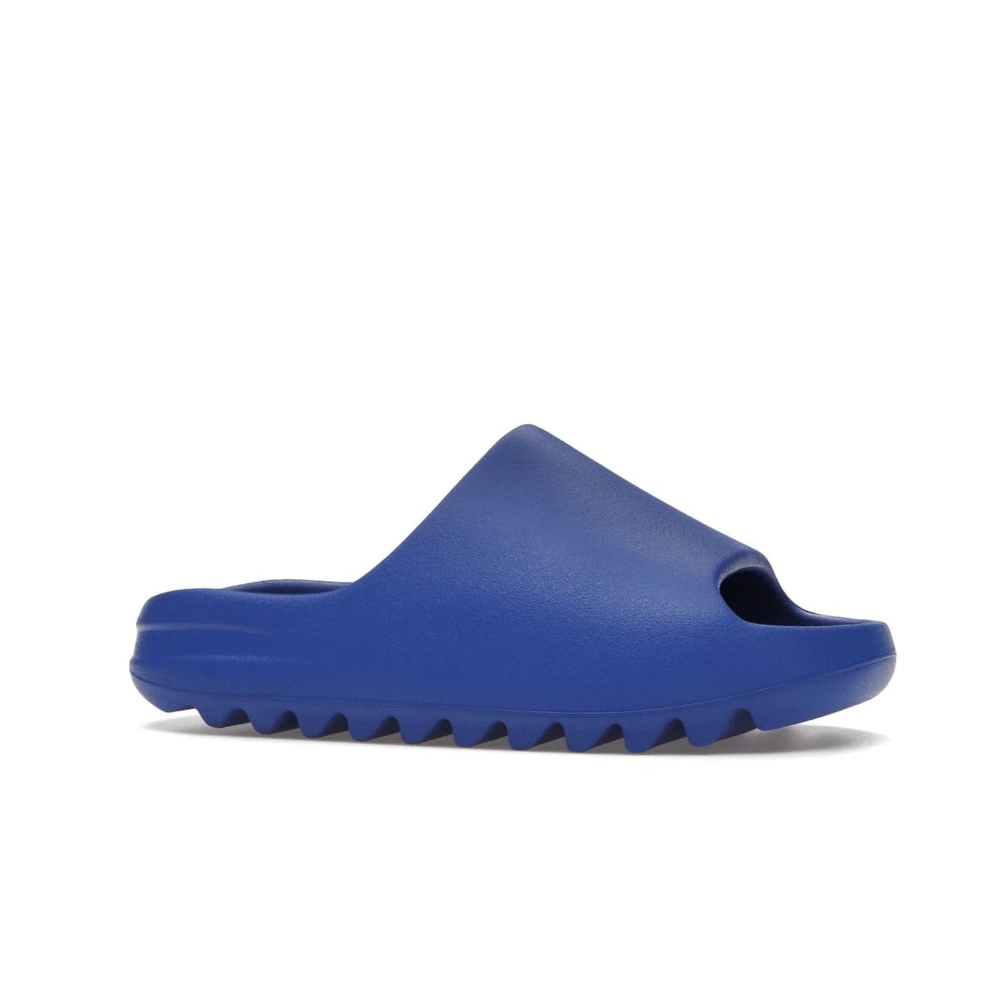 adidas Yeezy Slide Azure - Image 3 - Only at www.BallersClubKickz.com - Elevate your look with the adidas Yeezy Slide Azure. Boasting a vibrant hue for a unique style, this EVA foam slide is a statement of fearlessness and stylish expression. Step out with confidence knowing you're wearing more than a slide.