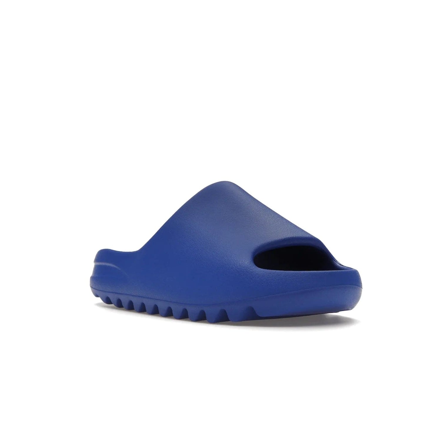 adidas Yeezy Slide Azure - Image 6 - Only at www.BallersClubKickz.com - Elevate your look with the adidas Yeezy Slide Azure. Boasting a vibrant hue for a unique style, this EVA foam slide is a statement of fearlessness and stylish expression. Step out with confidence knowing you're wearing more than a slide.