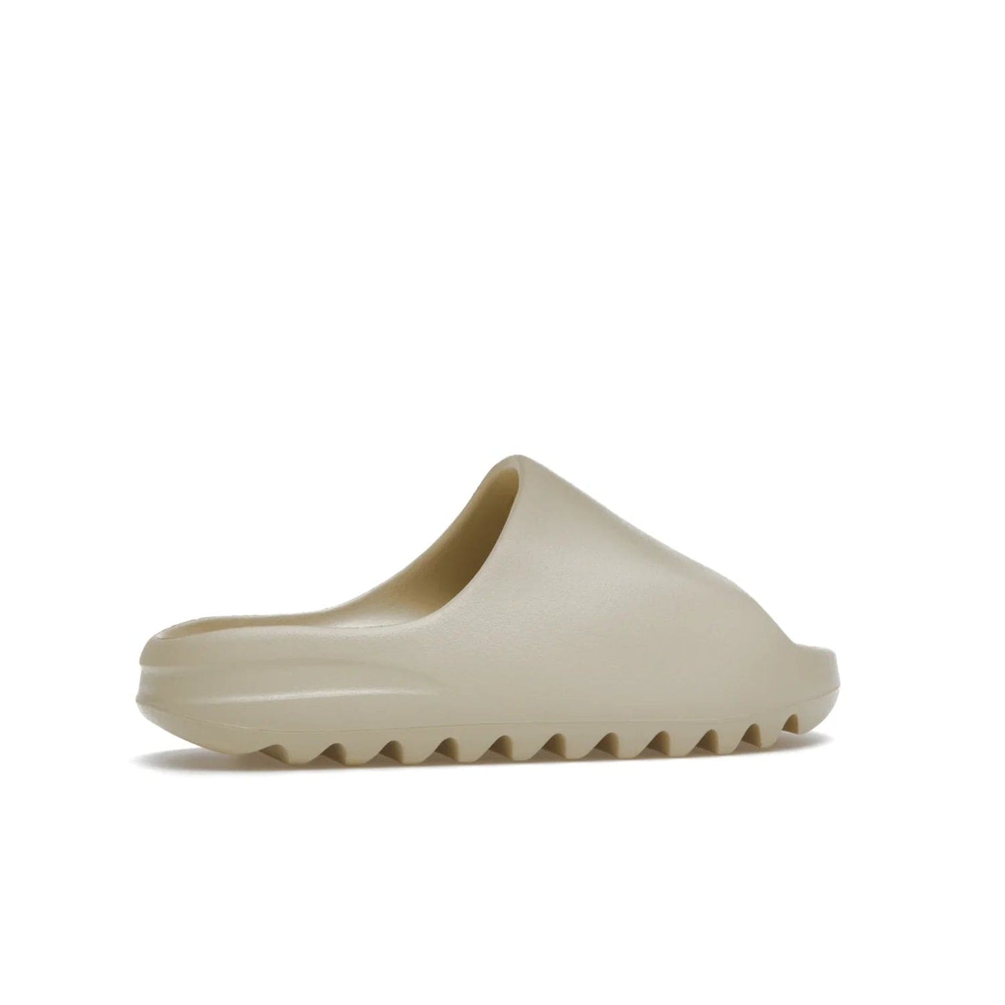 adidas Yeezy Slide Bone (2022 Restock) - Image 35 - Only at www.BallersClubKickz.com - Stay comfy with the adidas Yeezy Slide Bone - a fashionable silhouette with all-day comfort. This Bone/Bone/Bone colorway combines style and comfort with a pebbled texture and grooved sole. Restocked in May 2022, this shoe is the perfect addition to your collection.
