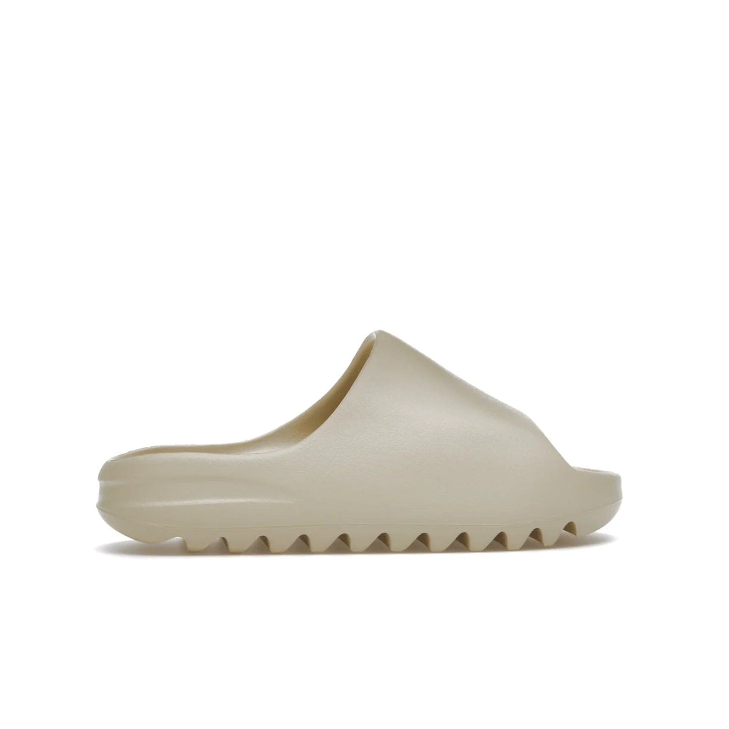 adidas Yeezy Slide Bone (2022 Restock) - Image 36 - Only at www.BallersClubKickz.com - Stay comfy with the adidas Yeezy Slide Bone - a fashionable silhouette with all-day comfort. This Bone/Bone/Bone colorway combines style and comfort with a pebbled texture and grooved sole. Restocked in May 2022, this shoe is the perfect addition to your collection.