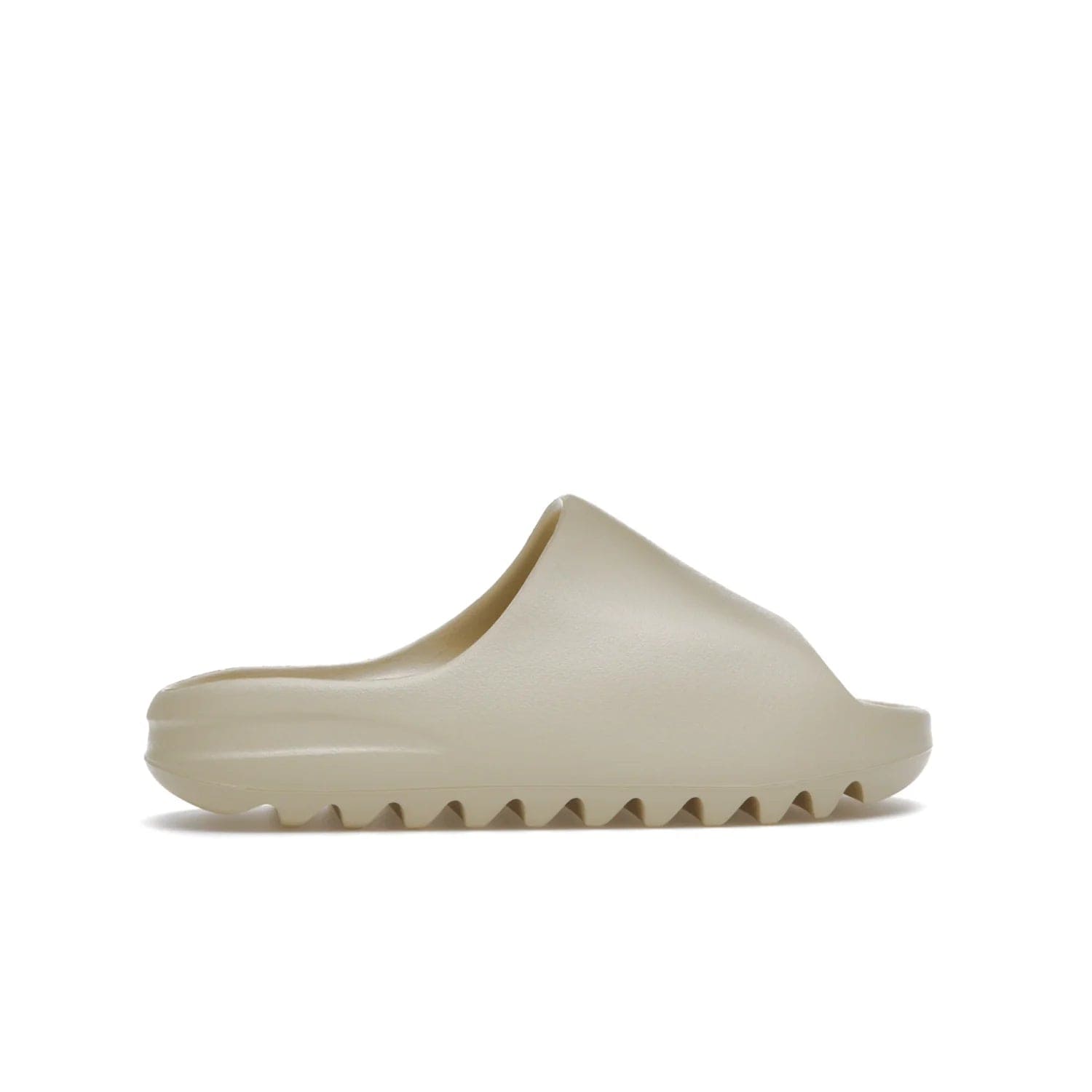 adidas Yeezy Slide Bone (2022 Restock) - Image 36 - Only at www.BallersClubKickz.com - Stay comfy with the adidas Yeezy Slide Bone - a fashionable silhouette with all-day comfort. This Bone/Bone/Bone colorway combines style and comfort with a pebbled texture and grooved sole. Restocked in May 2022, this shoe is the perfect addition to your collection.